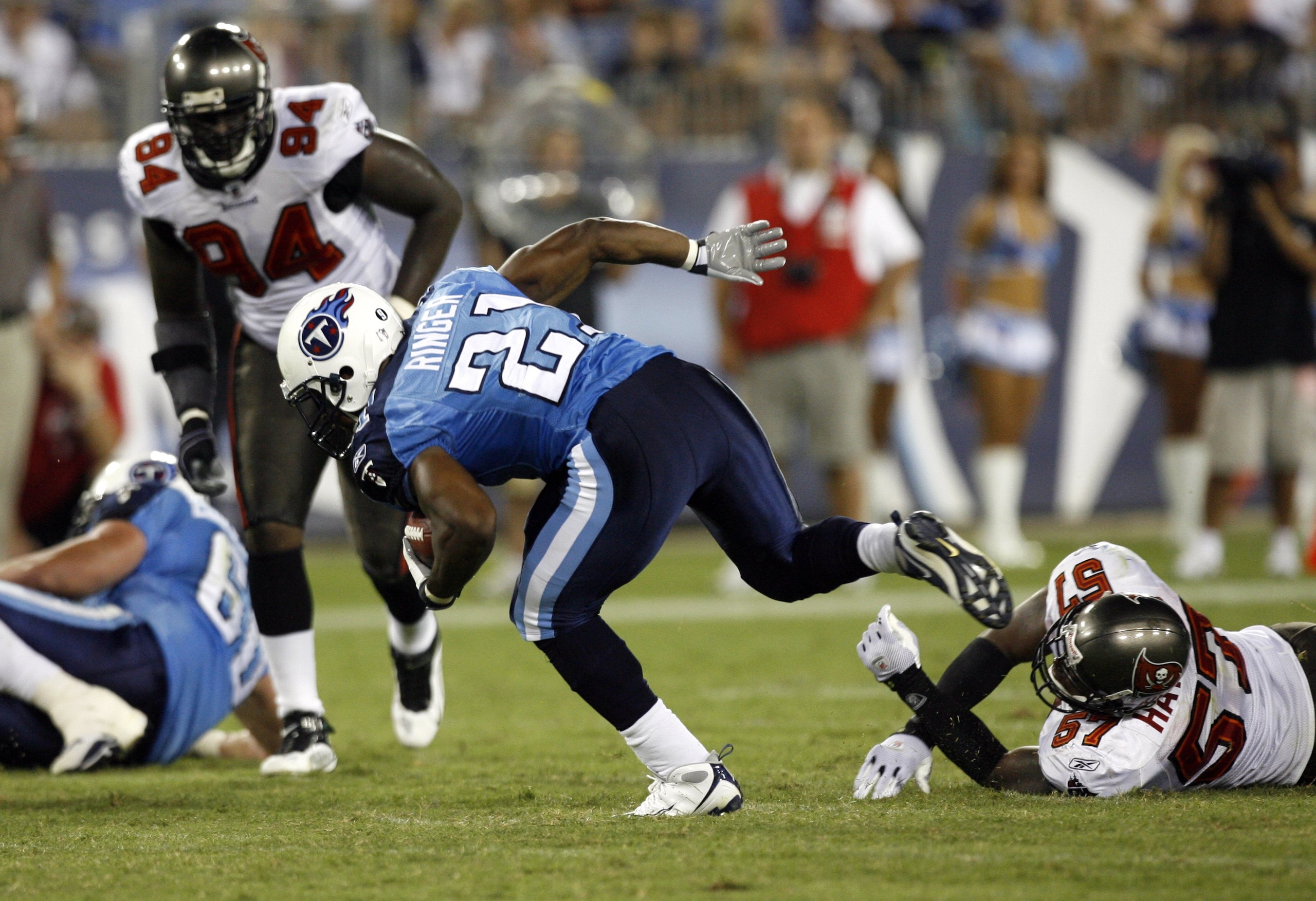 NASHVILLE, TN - AUGUST 15: Javon Ringer #21 of the Tennessee Titans breaks a tackle against Adam Hayward #57 of the Tampa Bay Buccaneers during a preseason NFL game at LP Field on August 15, 2009 in Nashville, Tennessee. The Titans beat the Buccaneers 27-