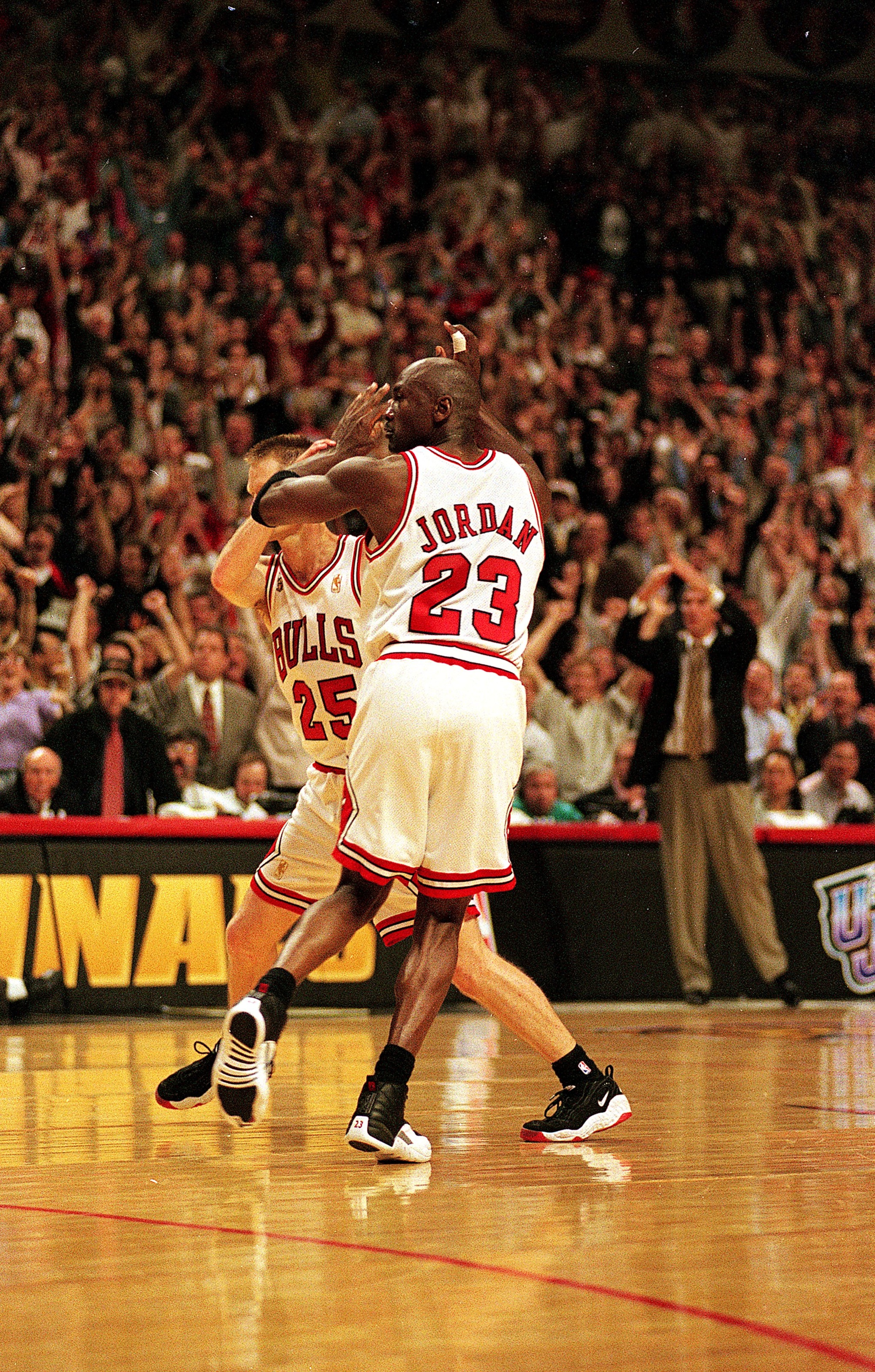 I3 Jun 1997:  Michael Jordan #23 of the Chicago Bulls celebrates with teammates Steve Kerr #25 during game six of the NBA Final against the Utah Jazz at the United Center in Chicago, Illinois. The Bulls defeated the Jazz 90-86..   Mandatory Credit: Jonath