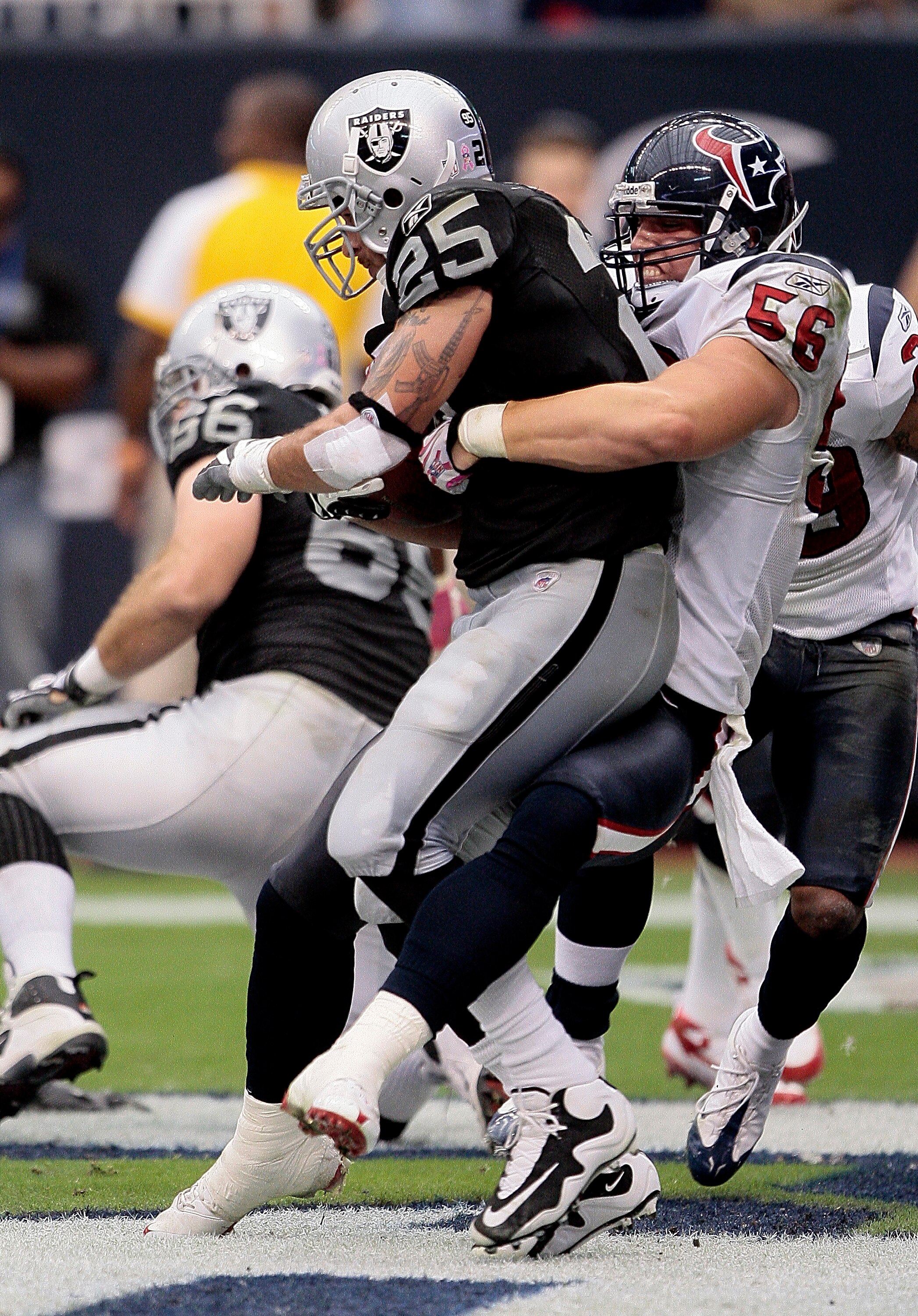 HOUSTON - OCTOBER 04:  Linebacker Brian Cushing #56 of the Houston Texans tackles  running back Justin Fargas #25 of the Oakland Raiders in the end-zone for a safety at Reliant Stadium on October 4, 2009 in Houston, Texas.  (Photo by Bob Levey/Getty Image