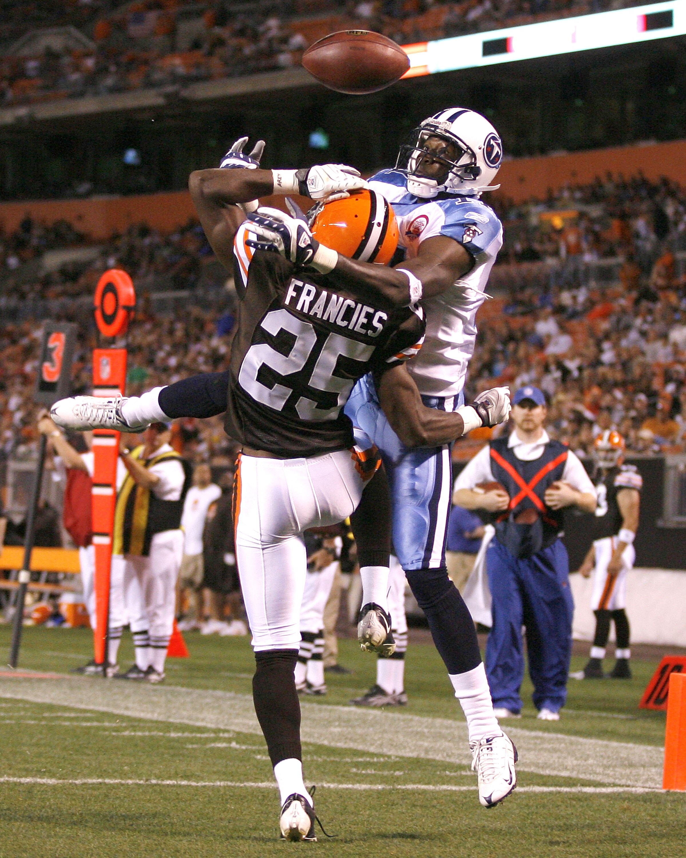 CLEVELAND - AUGUST 29:  Coye Francies #25 of the Cleveland Browns breaks up a pass to Paul Williams #11 of the Tennessee Titans at Cleveland Browns Stadium on August 29, 2009 in Cleveland, Ohio.  (Photo by Matt Sullivan/Getty Images)