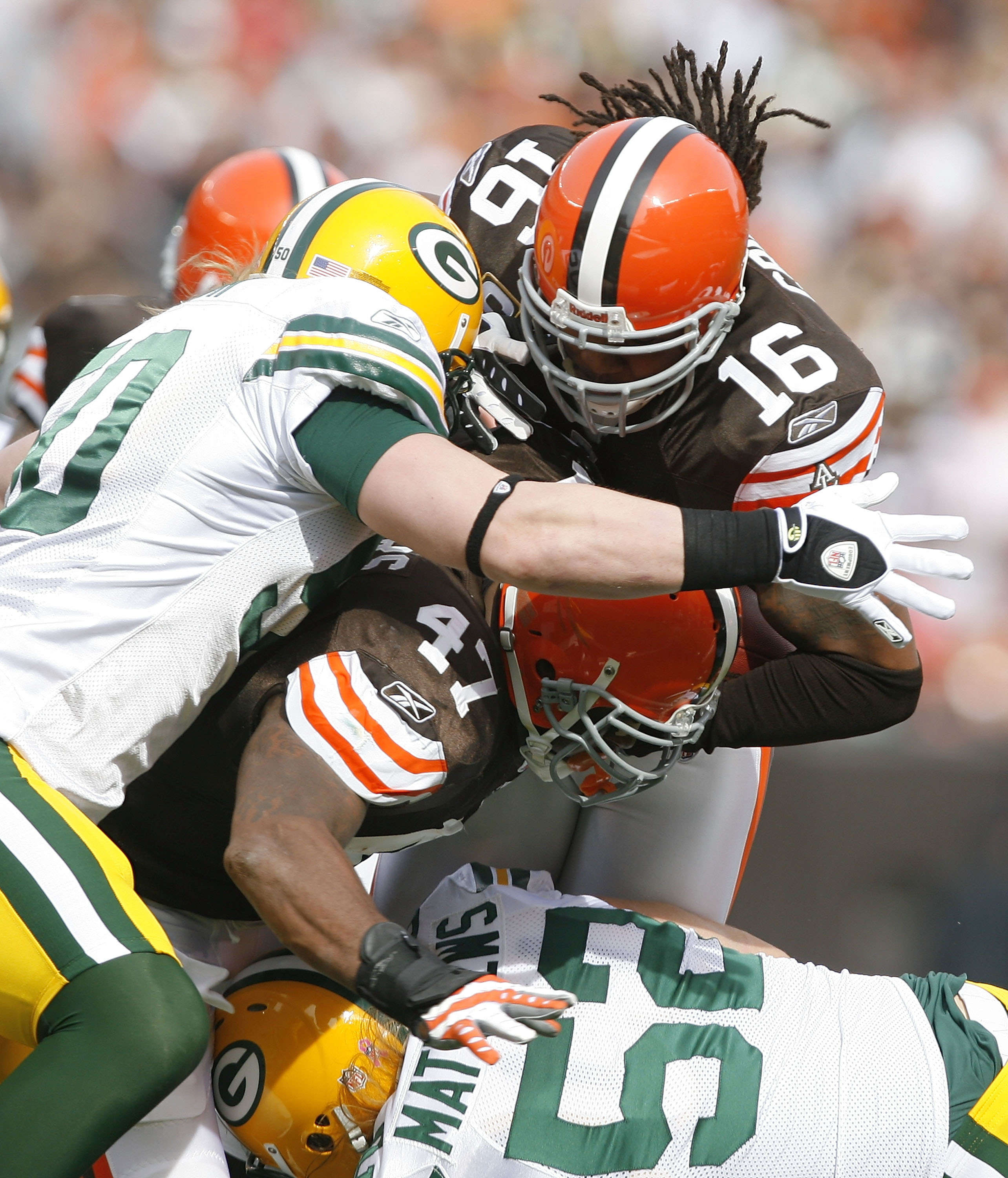 CLEVELAND, OH - OCTOBER 25:  Joshua Cribbs #16 of the Cleveland Browns is hit by A.J. Hawk #50 and Clay Matthews #52 of the Green Bay Packers at Cleveland Browns at Cleveland Browns Stadium on October 25, 2009 in Cleveland, Ohio.  (Photo by Matt Sullivan/