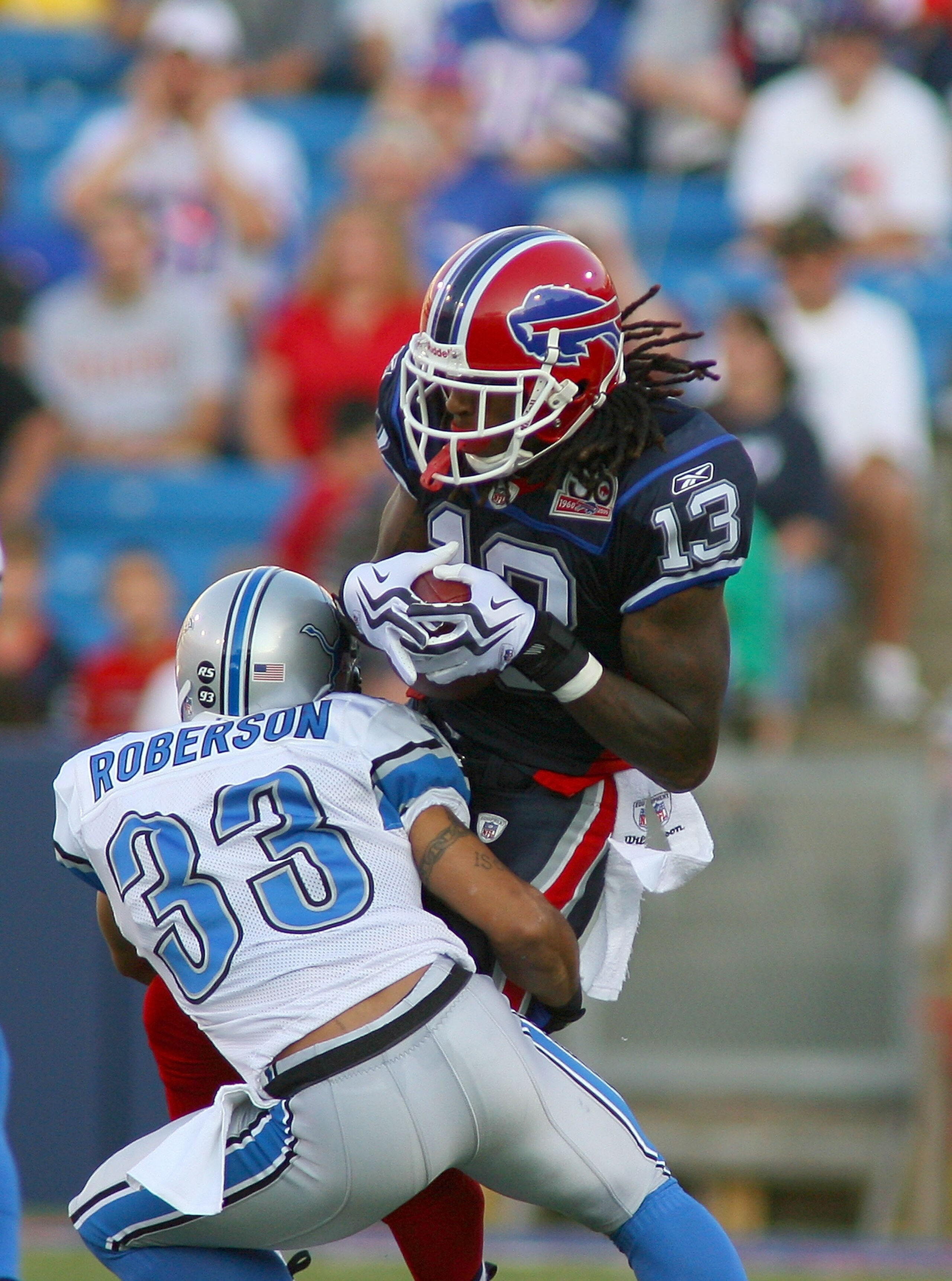 ORCHARD PARK, NY - SEPTEMBER 03:  Steve Johnson #13 of the Buffalo Bills is tackled after a catch by Chris Roberson #33 of The Detroit Lions at Ralph Wilson Stadium on September 3, 2009 in Orchard Park, New York.  (Photo by Rick Stewart/Getty Images)