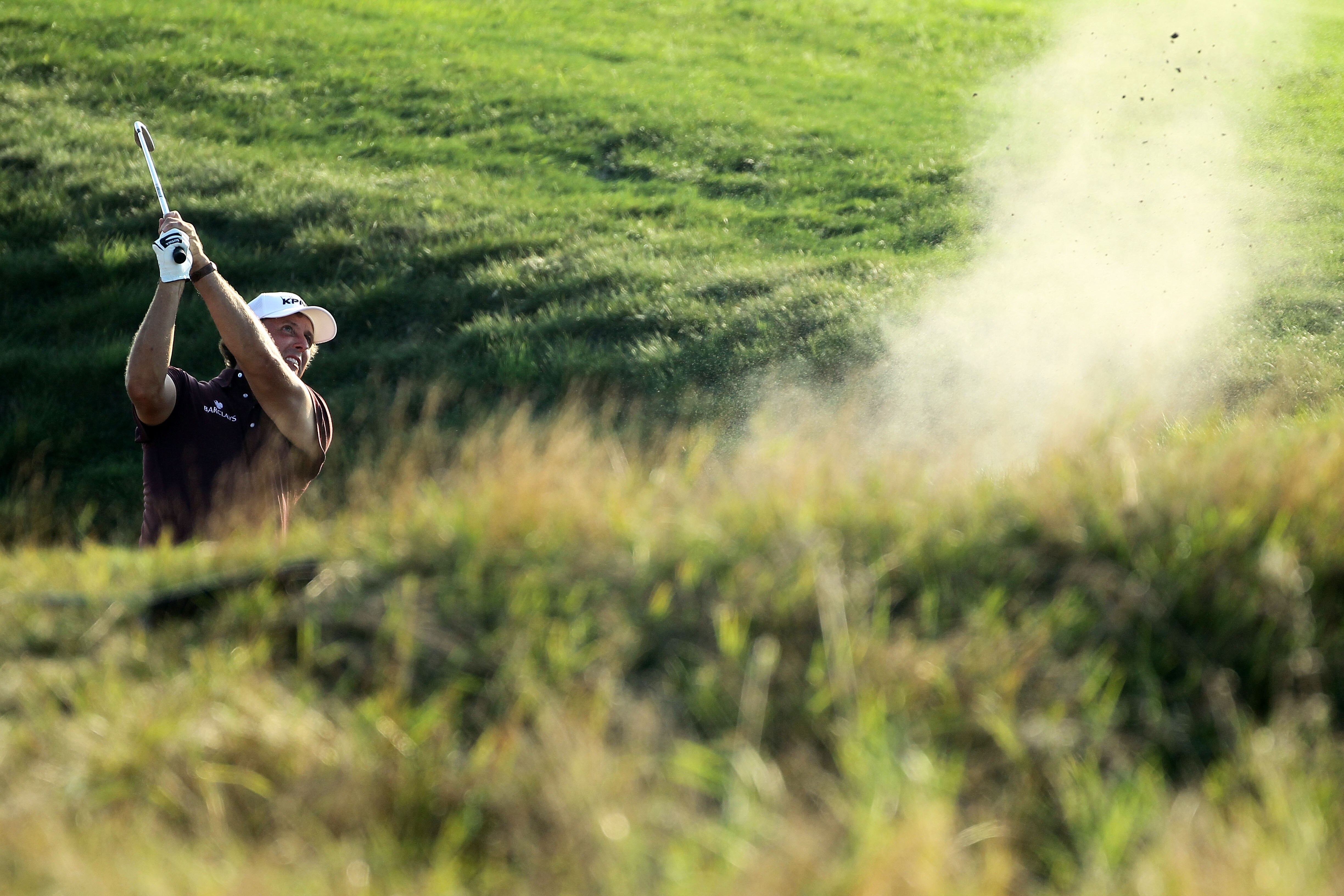 KOHLER, WI - AUGUST 12:  Phil Mickelson plays a bunker shot on the fifth hole during the first round of the 92nd PGA Championship on the Straits Course at Whistling Straits on August 12, 2010 in Kohler, Wisconsin.  (Photo by Andy Lyons/Getty Images)
