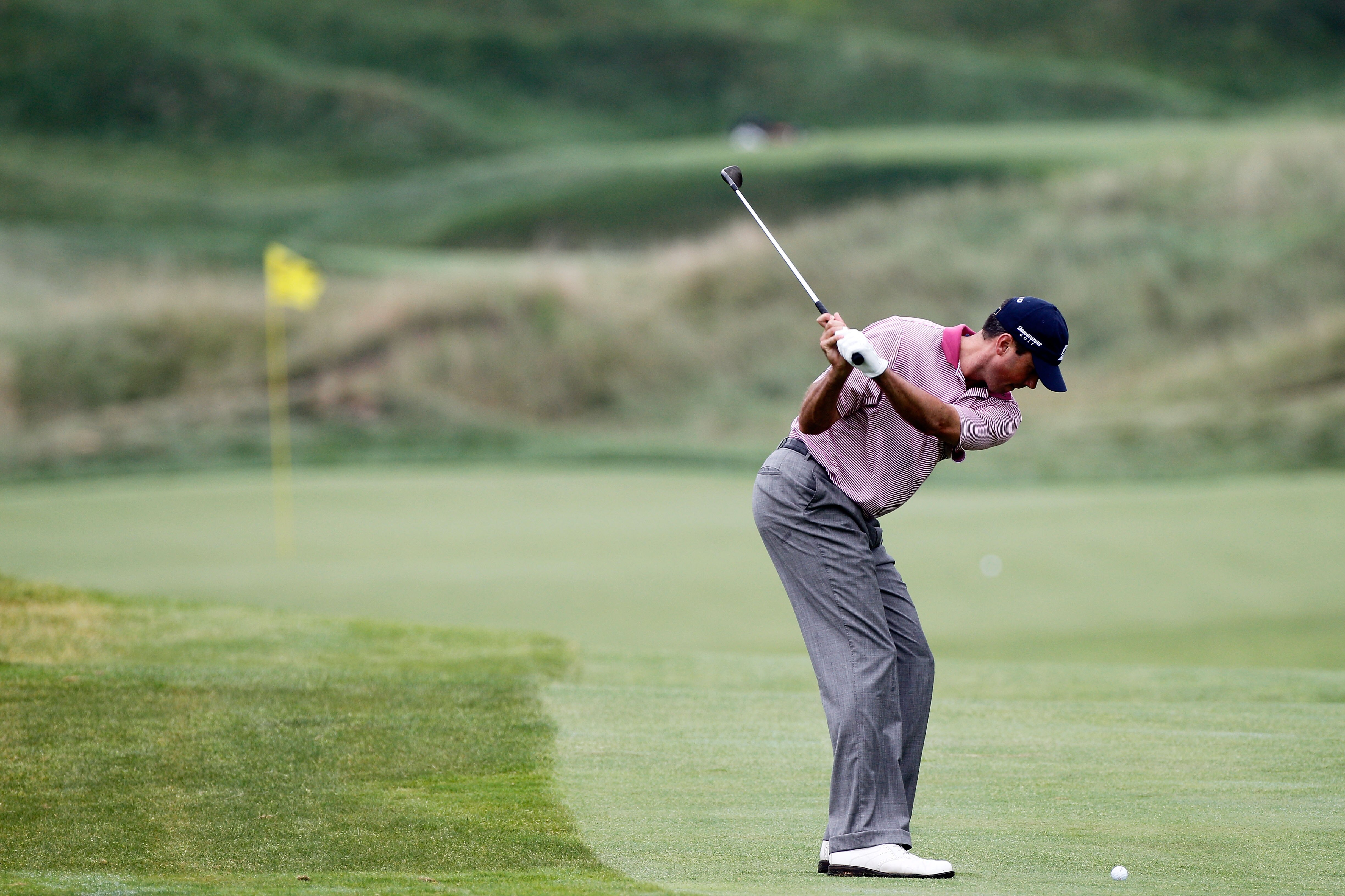 KOHLER, WI - AUGUST 13:  Matt Kuchar hits his approach shot on the ninth hole during the continuation of the first round of the 92nd PGA Championship on the Straits Course at Whistling Straits on August 13, 2010 in Kohler, Wisconsin.  (Photo by Sam Greenw