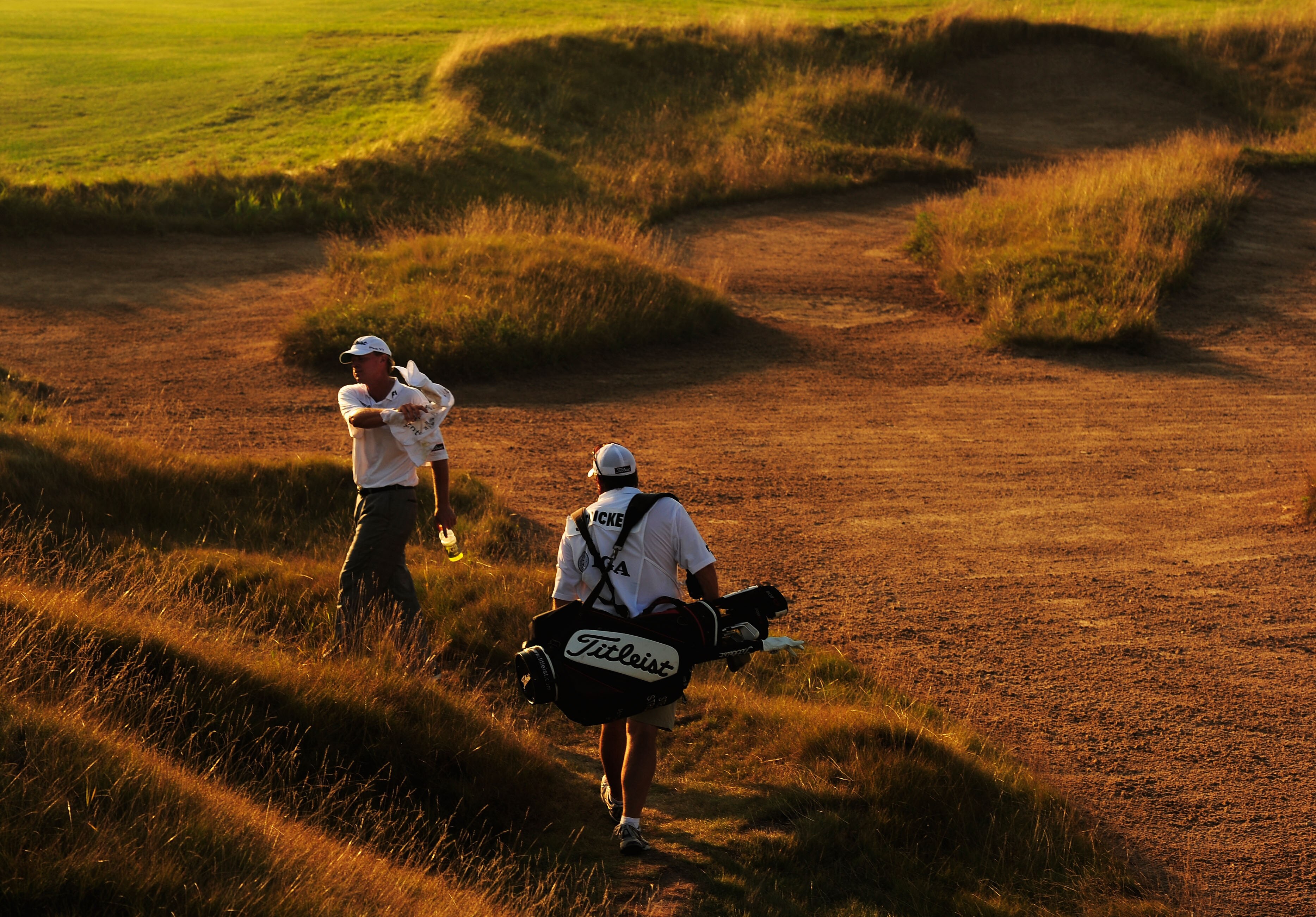 KOHLER, WI - AUGUST 12:  Steve Stricker grabs his golf towel on the ninth hole as his caddie Jimmy Johnson looks on during the first round of the 92nd PGA Championship on the Straits Course at Whistling Straits on August 12, 2010 in Kohler, Wisconsin.  (P