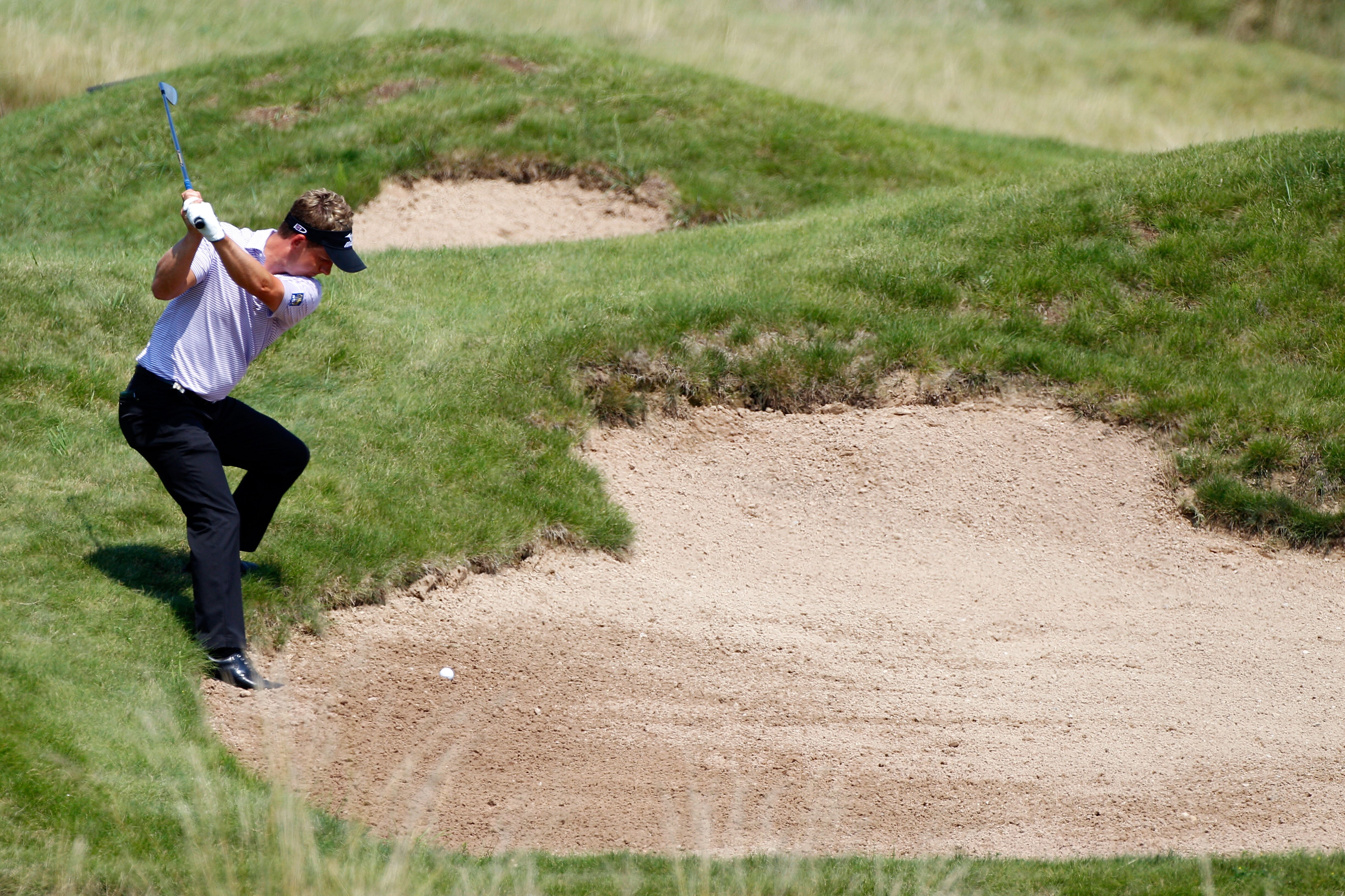 KOHLER, WI - AUGUST 12:  Luke Donald of England hits a shot from a bunker on the 11th hole during the first round of the 92nd PGA Championship on the Straits Course at Whistling Straits on August 12, 2010 in Kohler, Wisconsin.  (Photo by Sam Greenwood/Get