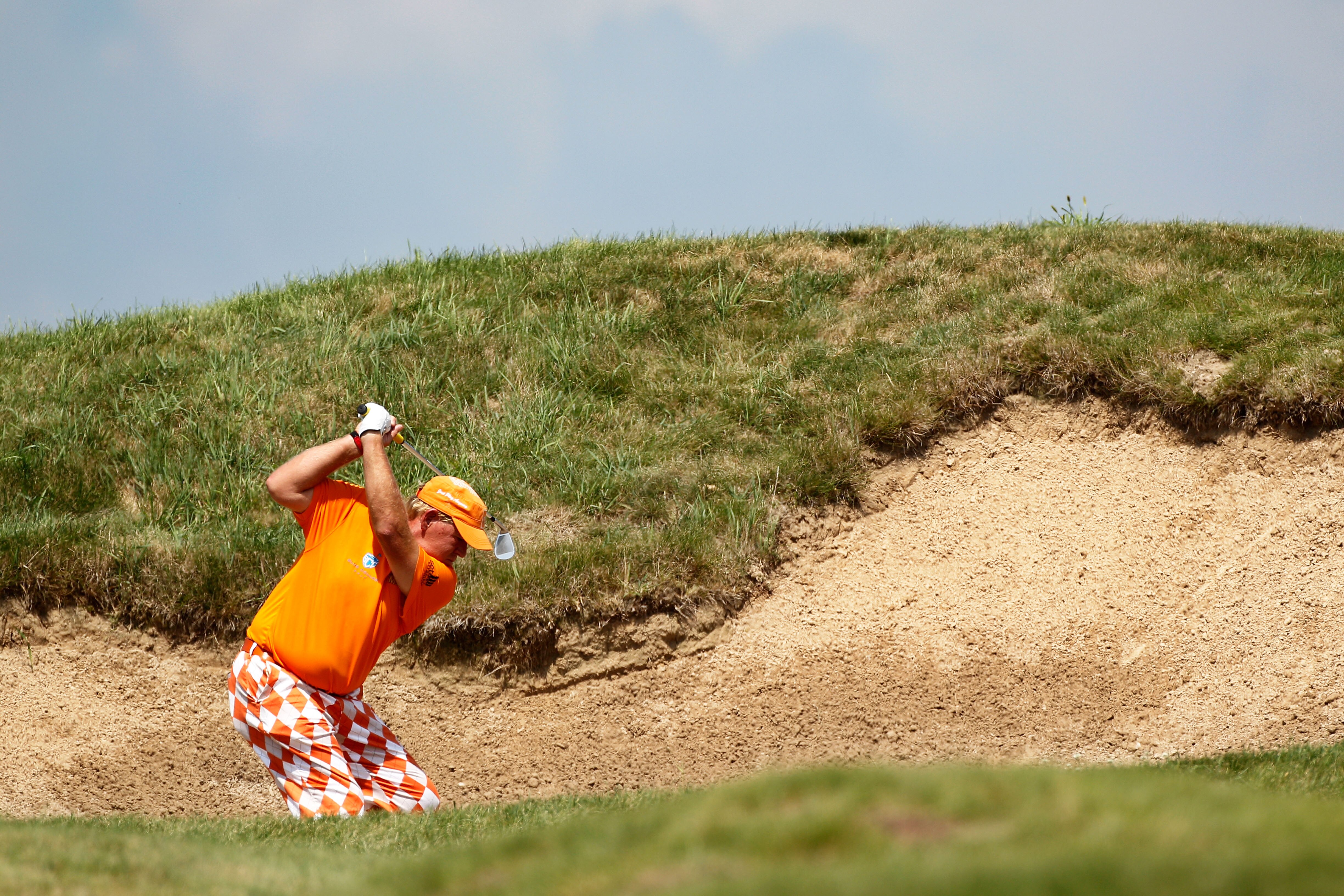 KOHLER, WI - AUGUST 12:  John Daly hits a shot from a bunker on the 11th hole during the first round of the 92nd PGA Championship on the Straits Course at Whistling Straits on August 12, 2010 in Kohler, Wisconsin.  (Photo by Sam Greenwood/Getty Images)