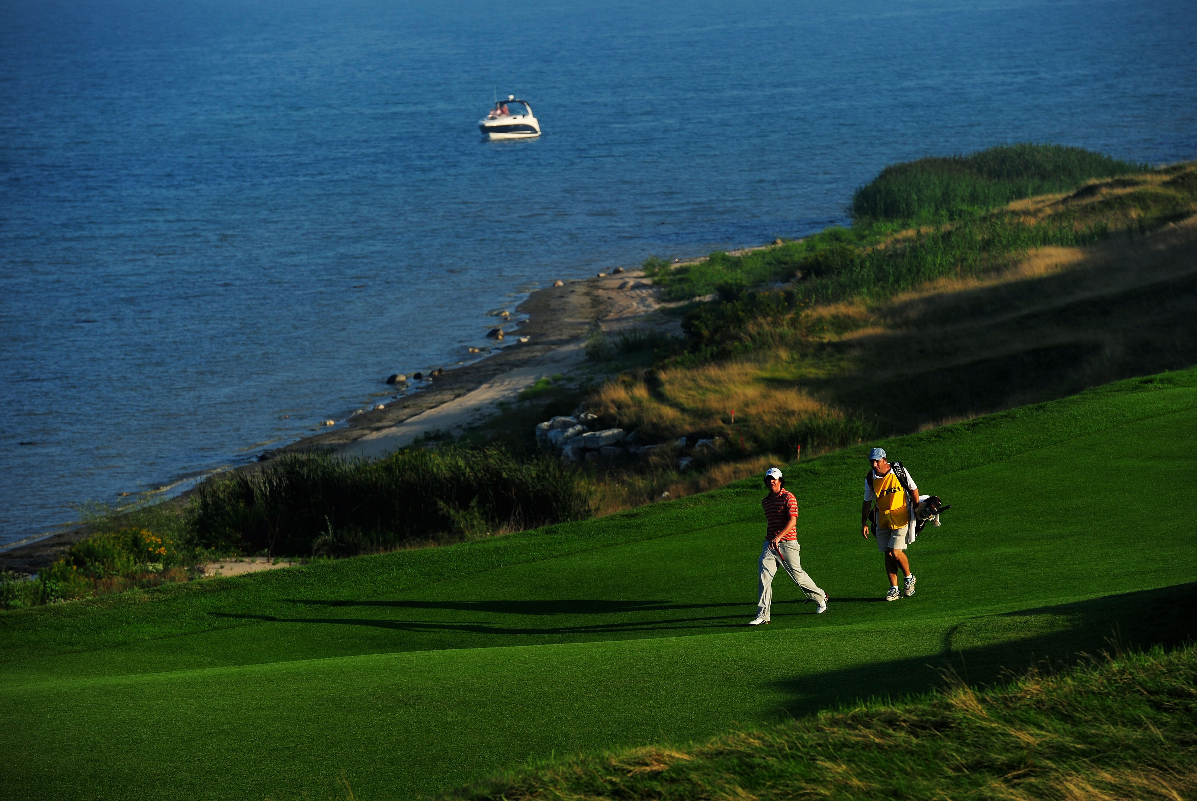 KOHLER, WI - AUGUST 12:  Rory McIlroy of Northern Ireland walks with his caddie J.P. Fitzgerald on the eighth hole during the first round of the 92nd PGA Championship on the Straits Course at Whistling Straits on August 12, 2010 in Kohler, Wisconsin.  (Ph