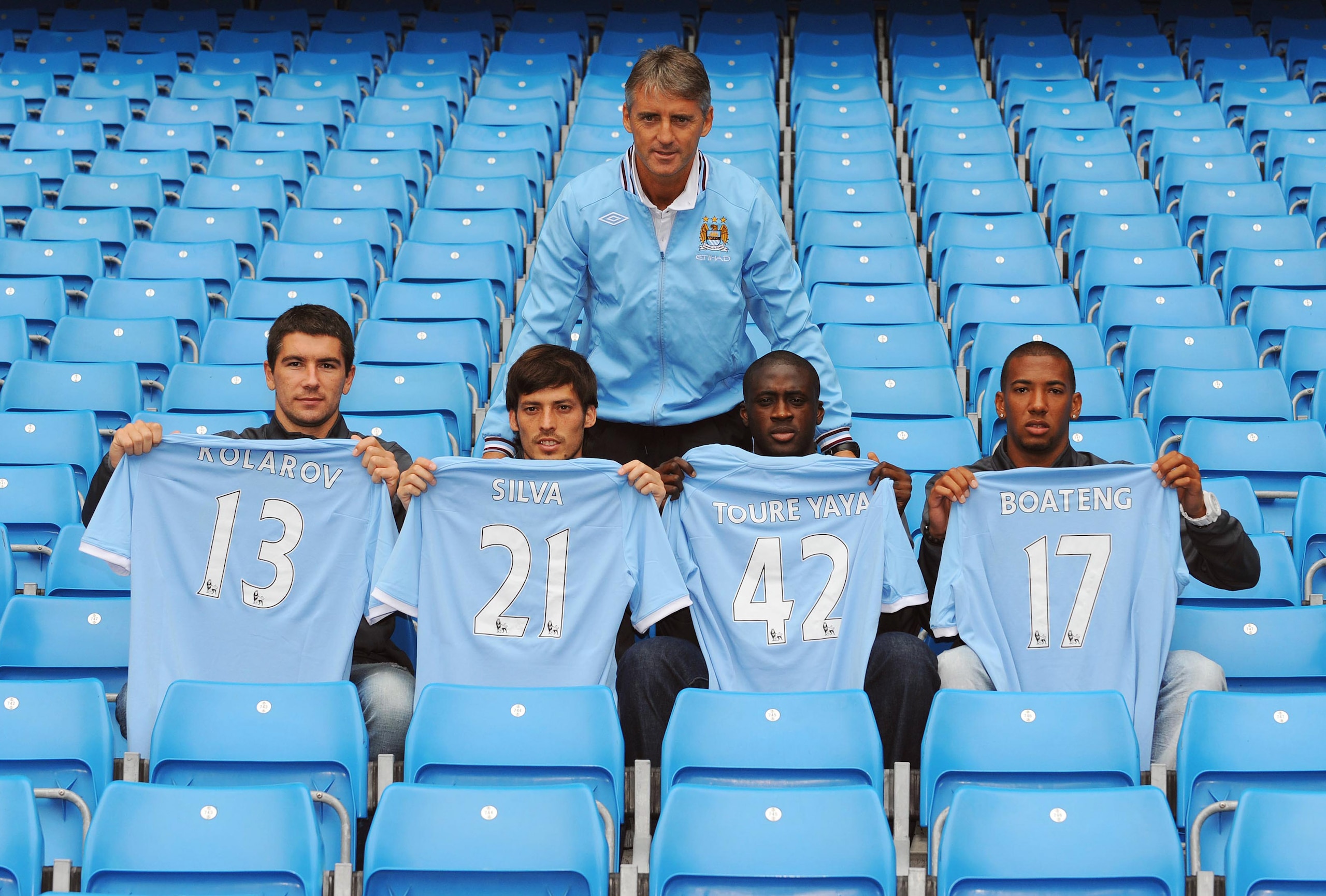 MANCHESTER, ENGLAND - AUGUST 6:  Manager Roberto Mancini (C) poses with new signings (L-R) Aleksandar Kolarov, David Silva, Yaya Toure and Jerome Boateng during a Manchester City training session at the City of Manchester Stadium on August 6, 2010 in Manc