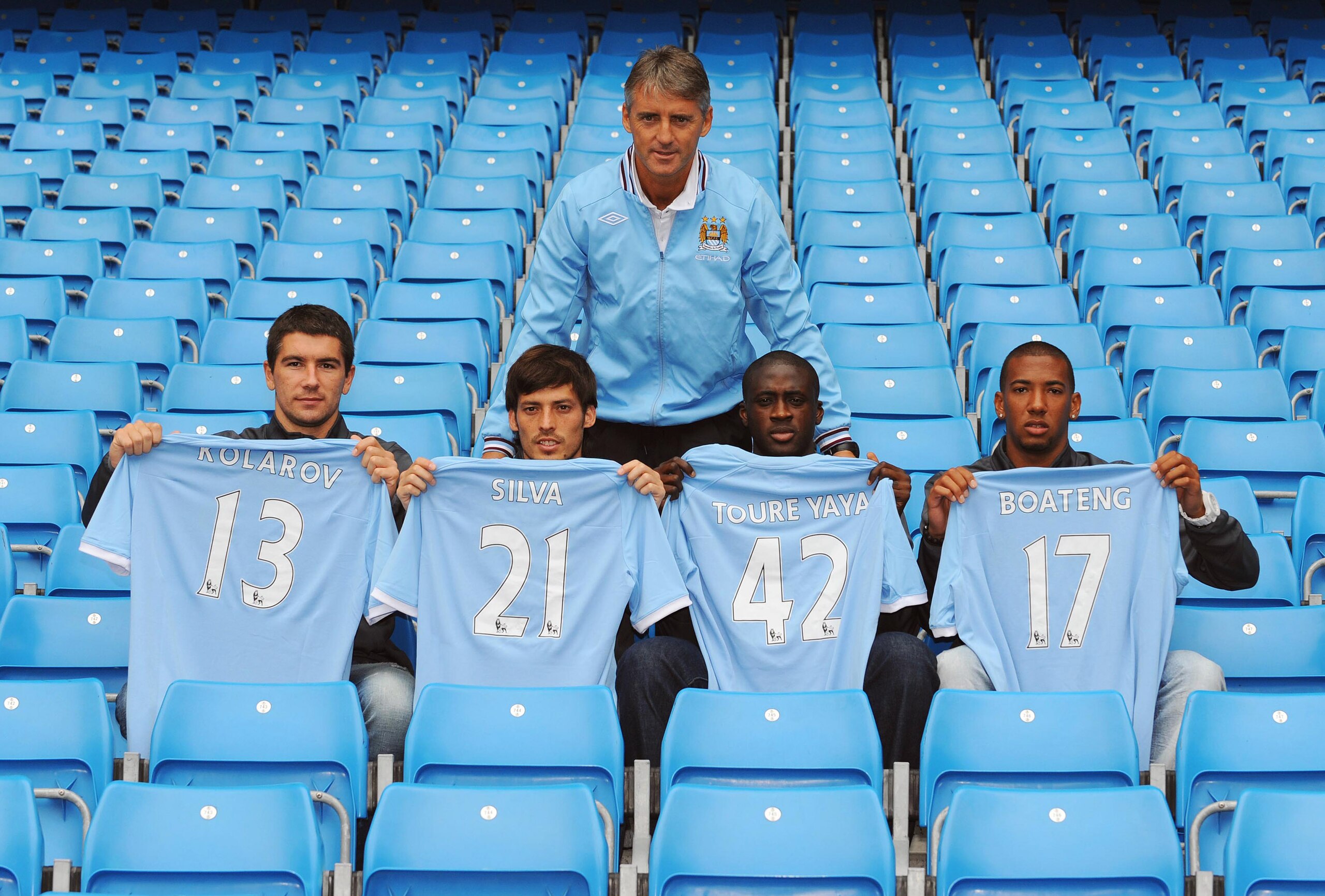 MANCHESTER, ENGLAND - AUGUST 6:  Manager Roberto Mancini (C) poses with new signings (L-R) Aleksandar Kolarov, David Silva, Yaya Toure and Jerome Boateng during a Manchester City training session at the City of Manchester Stadium on August 6, 2010 in Manc