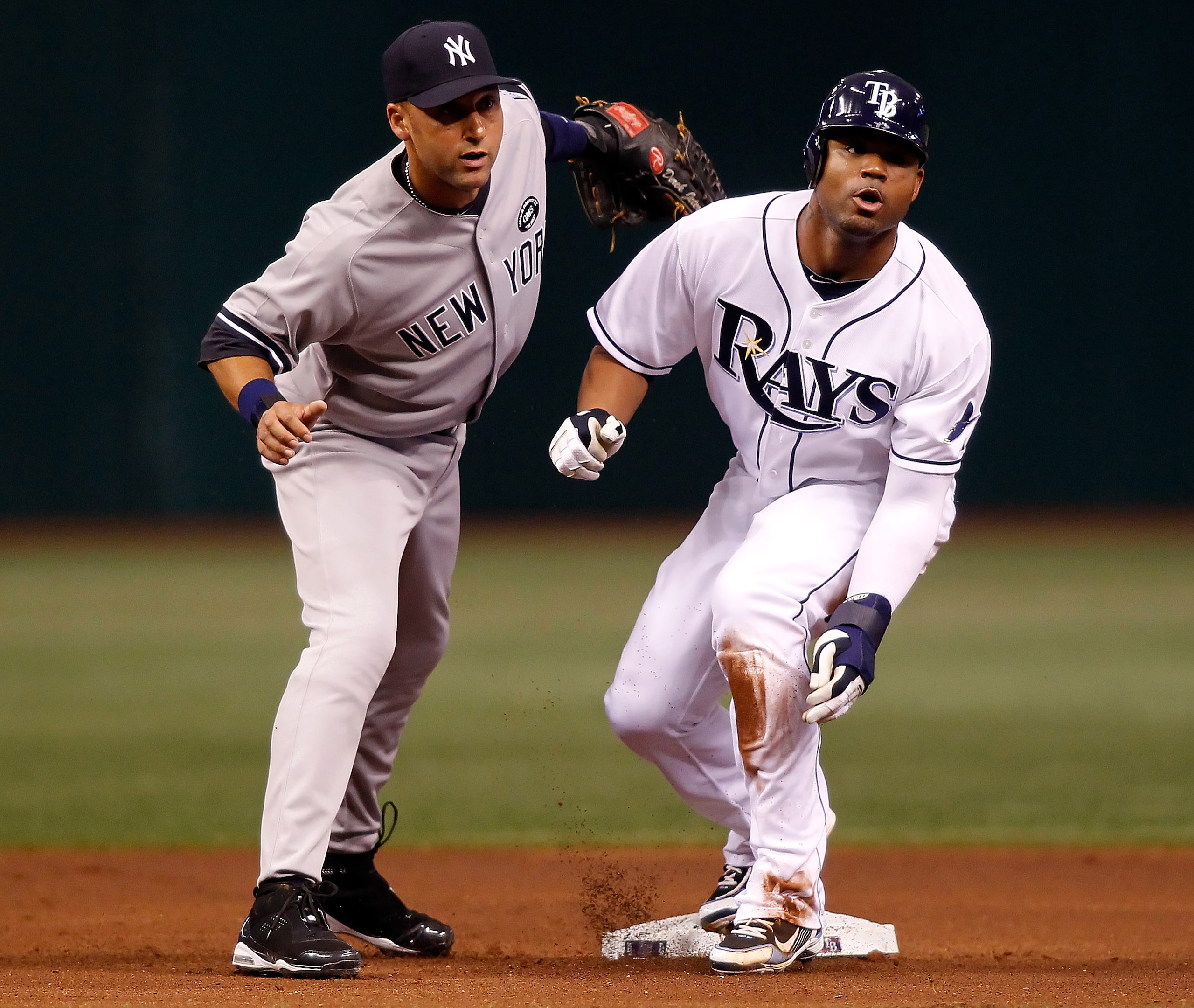 ST PETERSBURG, FL - JULY 31: Outfielder Carl Crawford #13 of the Tampa Bay Rays steals his 400th career base as shortstop Derek Jeter #2 of the New York Yankees is late with the tag during the game at Tropicana Field on July 31, 2010 in St. Petersburg, F ST PETERSBURG, FL - JULY 31: Outfielder Carl Crawford #13 of the Tampa Bay Rays steals his 400th career base as shortstop Derek Jeter #2 of the New York Yankees is late with the tag during the game at Tropicana Field on July 31, 2010 in St. Petersburg, F