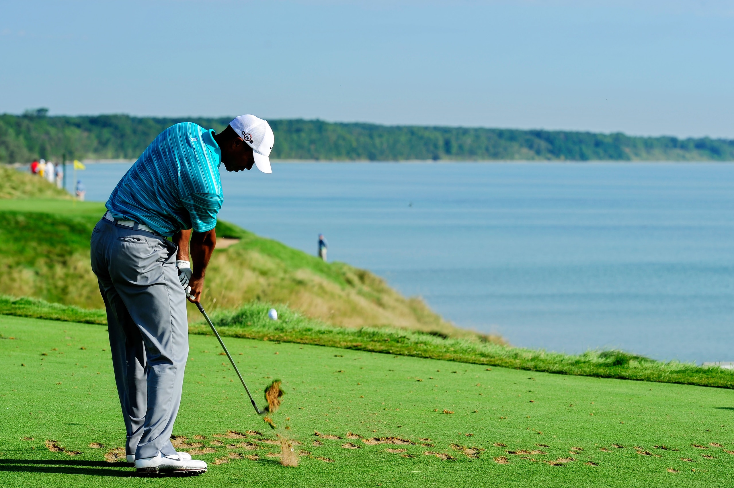 KOHLER, WI - AUGUST 14:  Tiger Woods hits his tee shot on the 12th hole during the continuation of the second round of the 92nd PGA Championship on the Straits Course at Whistling Straits on August 14, 2010 in Kohler, Wisconsin.  (Photo by Stuart Franklin