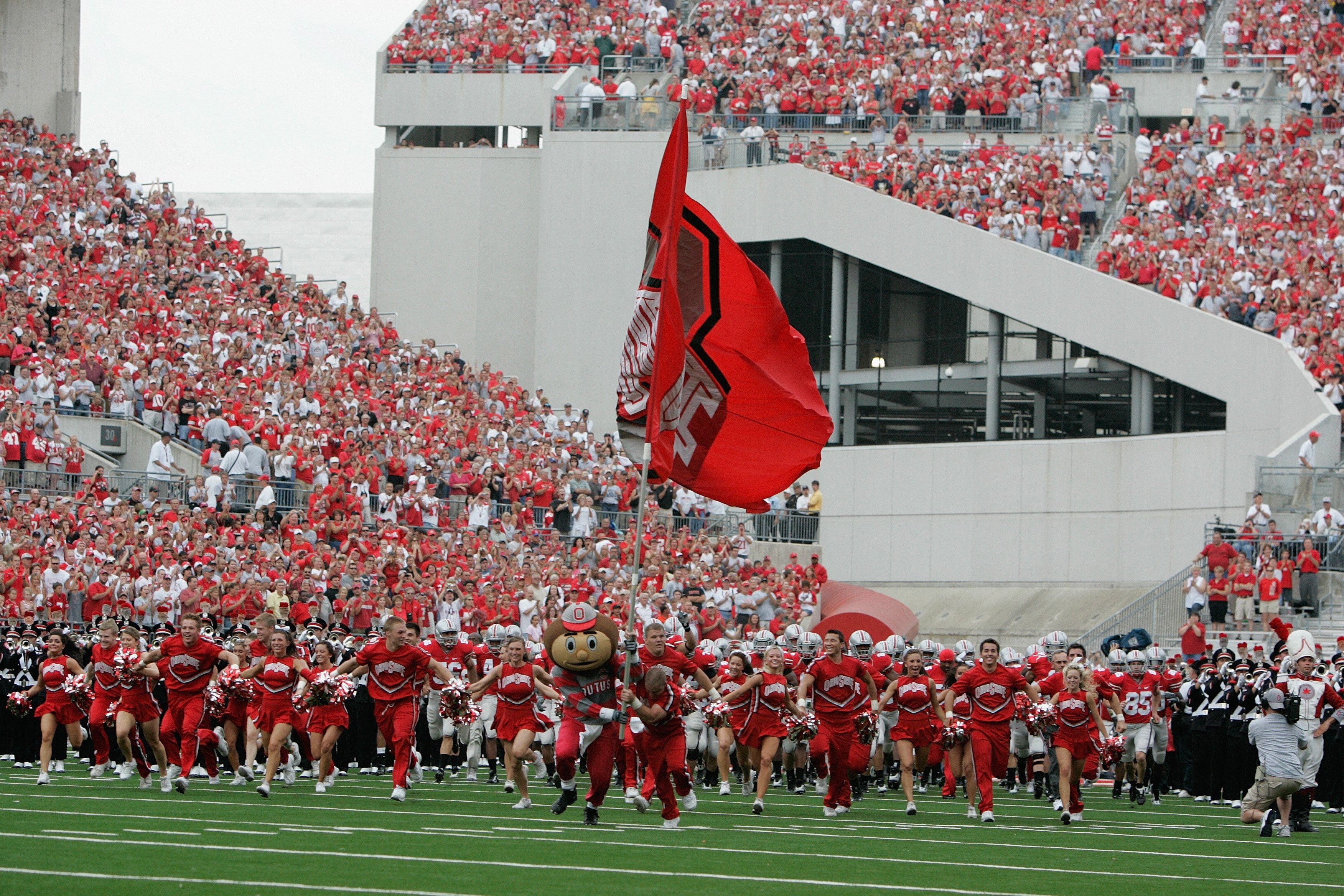 COLUMBUS, OH - SEPTEMBER 8:  The Ohio State Buckeyes mascot Brutus Buckeye and cheerleaders lead the team onto the field before the game against the Akron Zips at Ohio Stadium on September 8, 2007 in Columbus, Ohio. Ohio State won 20-2. (Photo by David Ma