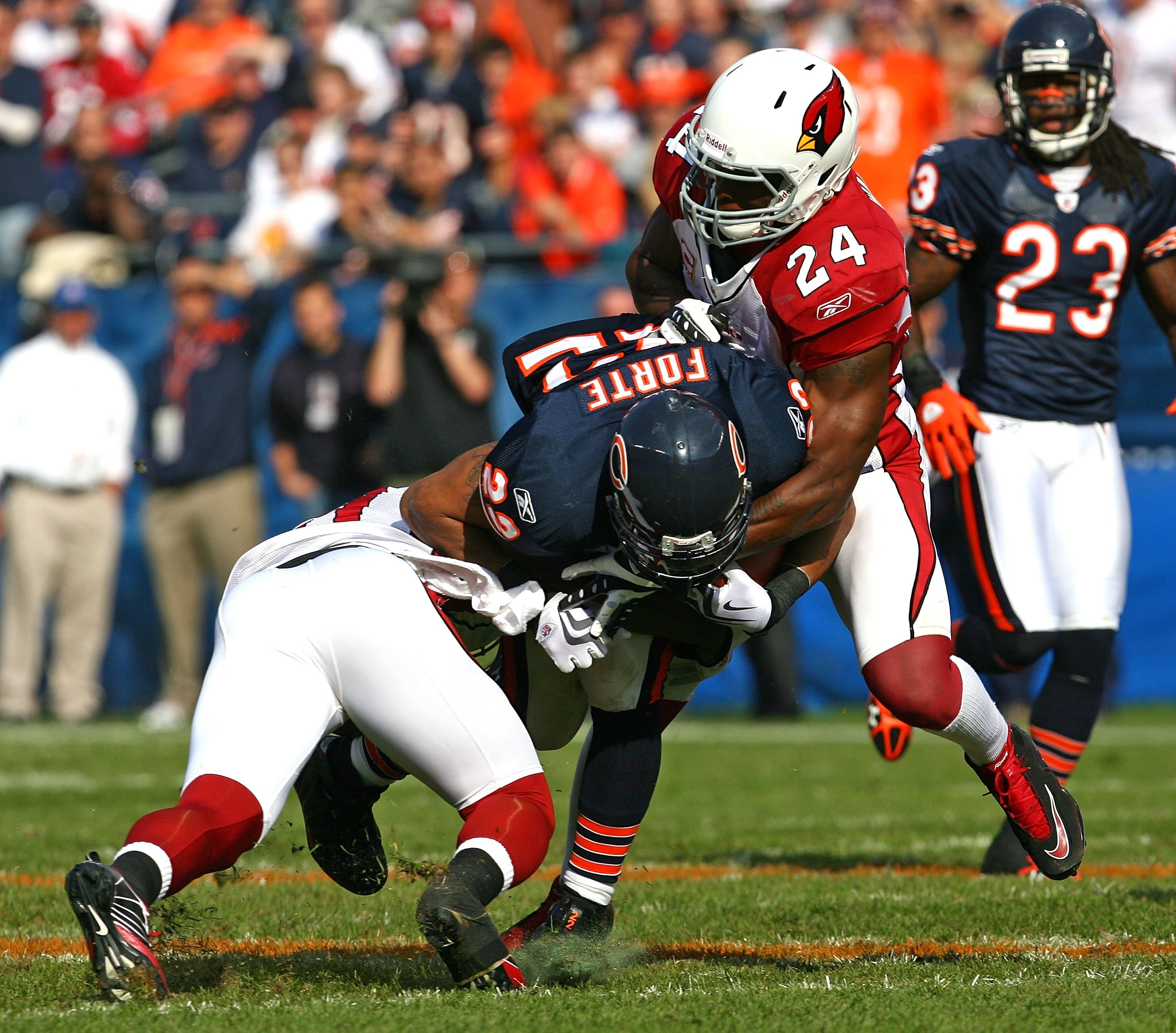 CHICAGO - NOVEMBER 08: Matt Forte #22 of the Chicago Bears is tackled by Chike Okeafor #56 and Adrian Wilson #24 of the Arizona Cardinals at Soldier Field on November 8, 2009 in Chicago, Illinois. The Cardinals defeated the Bears 41-21. (Photo by Jonathan
