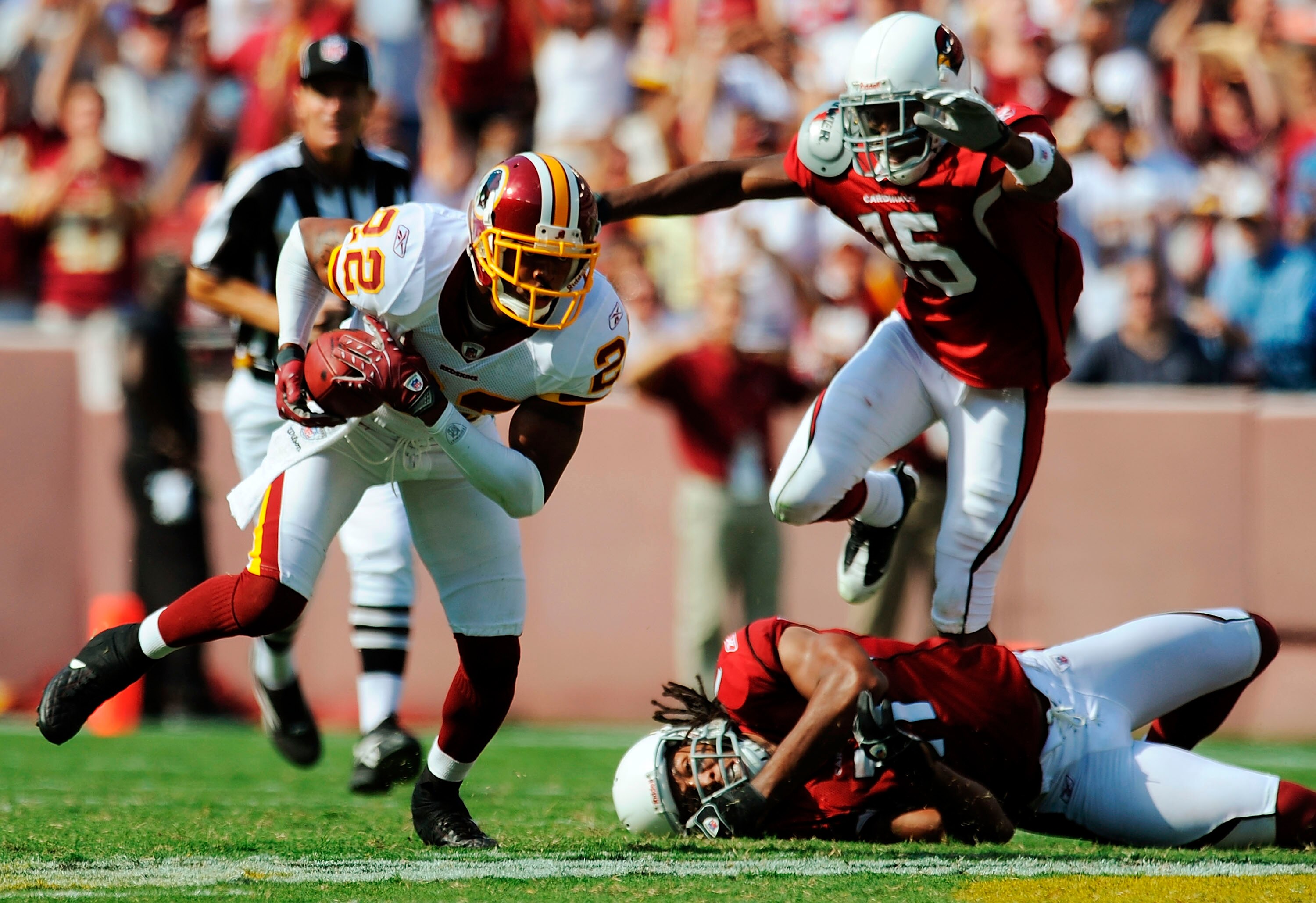 LANDOVER, MD - SEPTEMBER 21: Carlos Rogers #22 (L) of the Washington Redskins takes off on a long interception return against Arizona Cardinals Steve Breaston #15 (Top R) and Larry Fitzgerald #11 (Bottom R) at FedEx Field September 21, 2008 in Landover , 