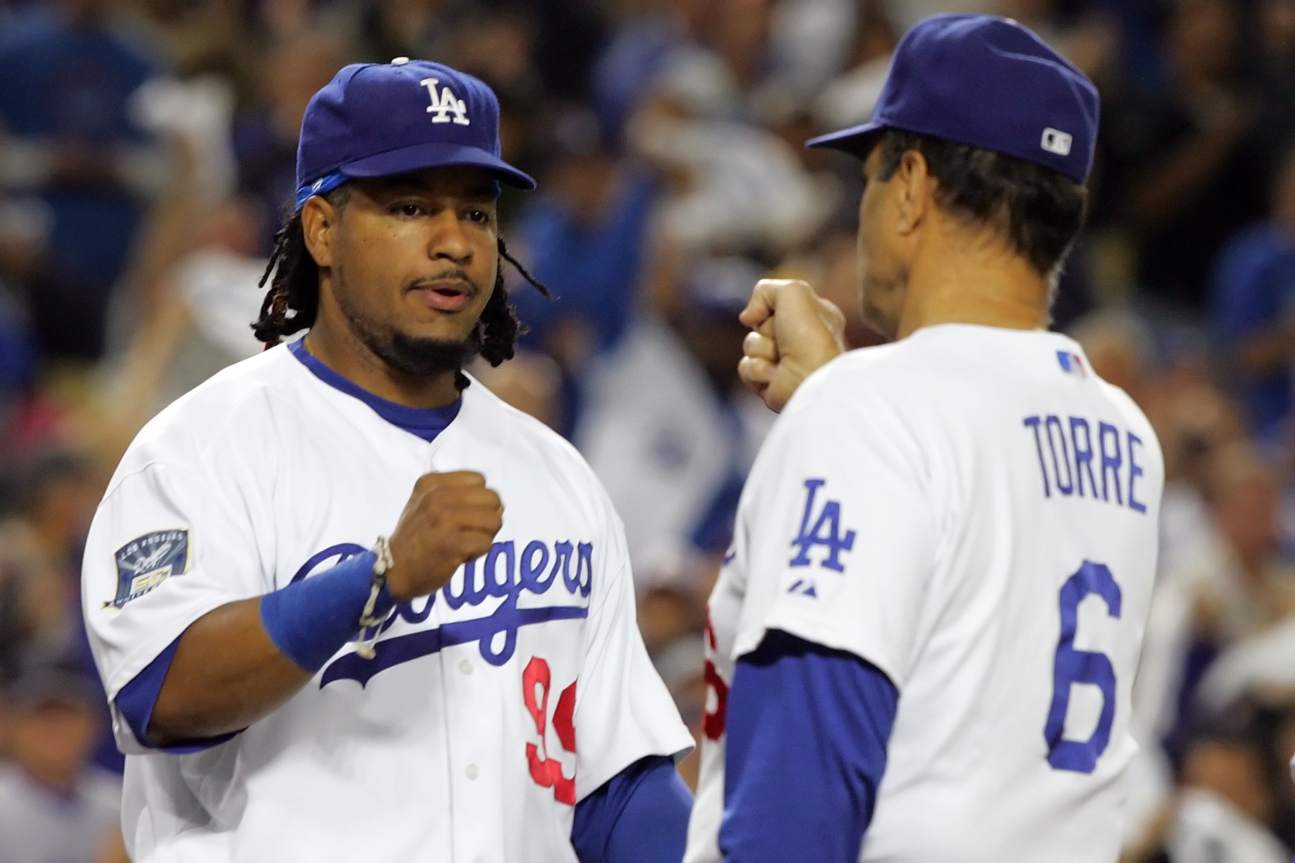 LOS ANGELES, CA - OCTOBER 04:  Manny Ramirez #99 of the Los Angeles Dodgers greets manager Joe Torre #6 of the Dodgers during pre-game introductions before taking on the Chicago Cubs in Game Three of the NLDS during the 2008 MLB playoffs on October 4, 200