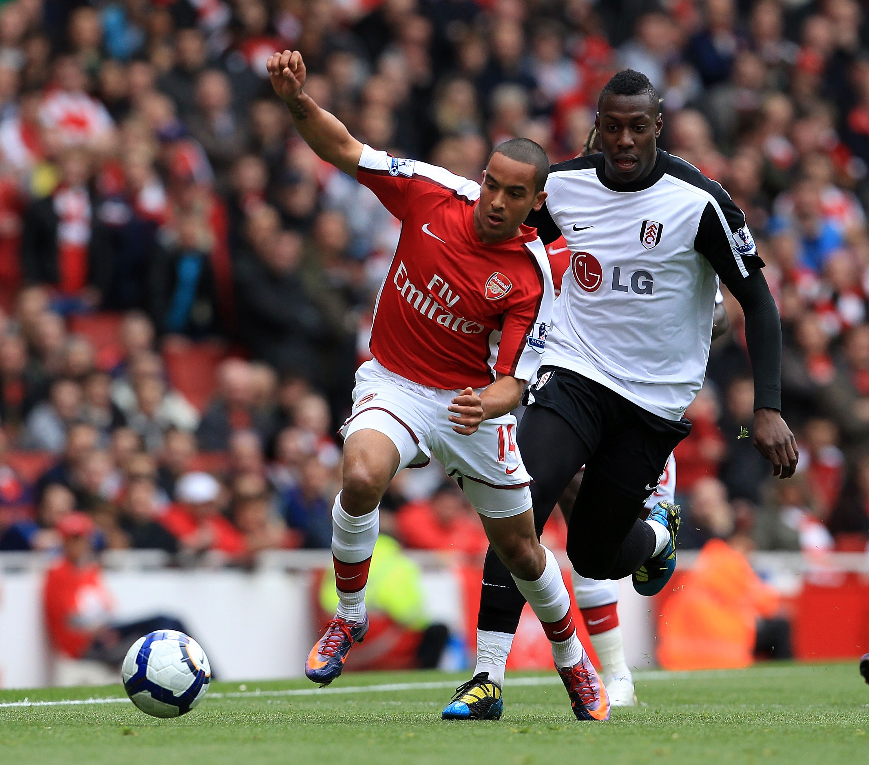 LONDON, ENGLAND - MAY 09:  Theo Walcott of Arsenal  tussles with Kagisho Dikgacoi of Fulham during the Barclays Premier League match between Arsenal and Fulham at The Emirates Stadium on May 9, 2010 in London, England.  (Photo by David Cannon/Getty Images