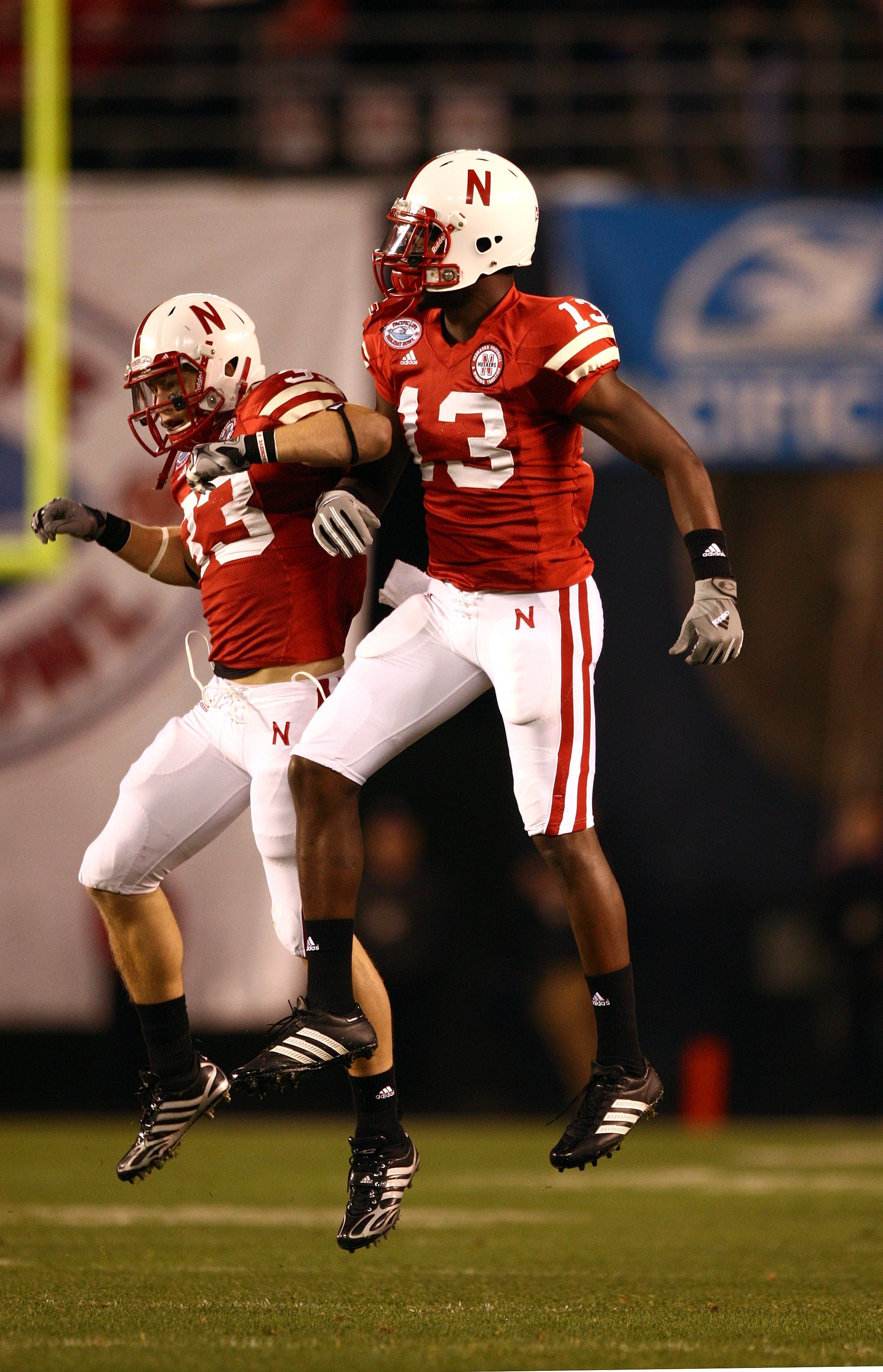 SAN DIEGO - DECEMBER 30:  P.J. Smith #13 and Matt O'Hanlon #33 of the University of Nebraska Cornhuskers celebrate after a defensive play during the Pacific Life Holiday Bowl against University of Arizona Wildcats on December 30, 2009 at Qualcomm Stadium