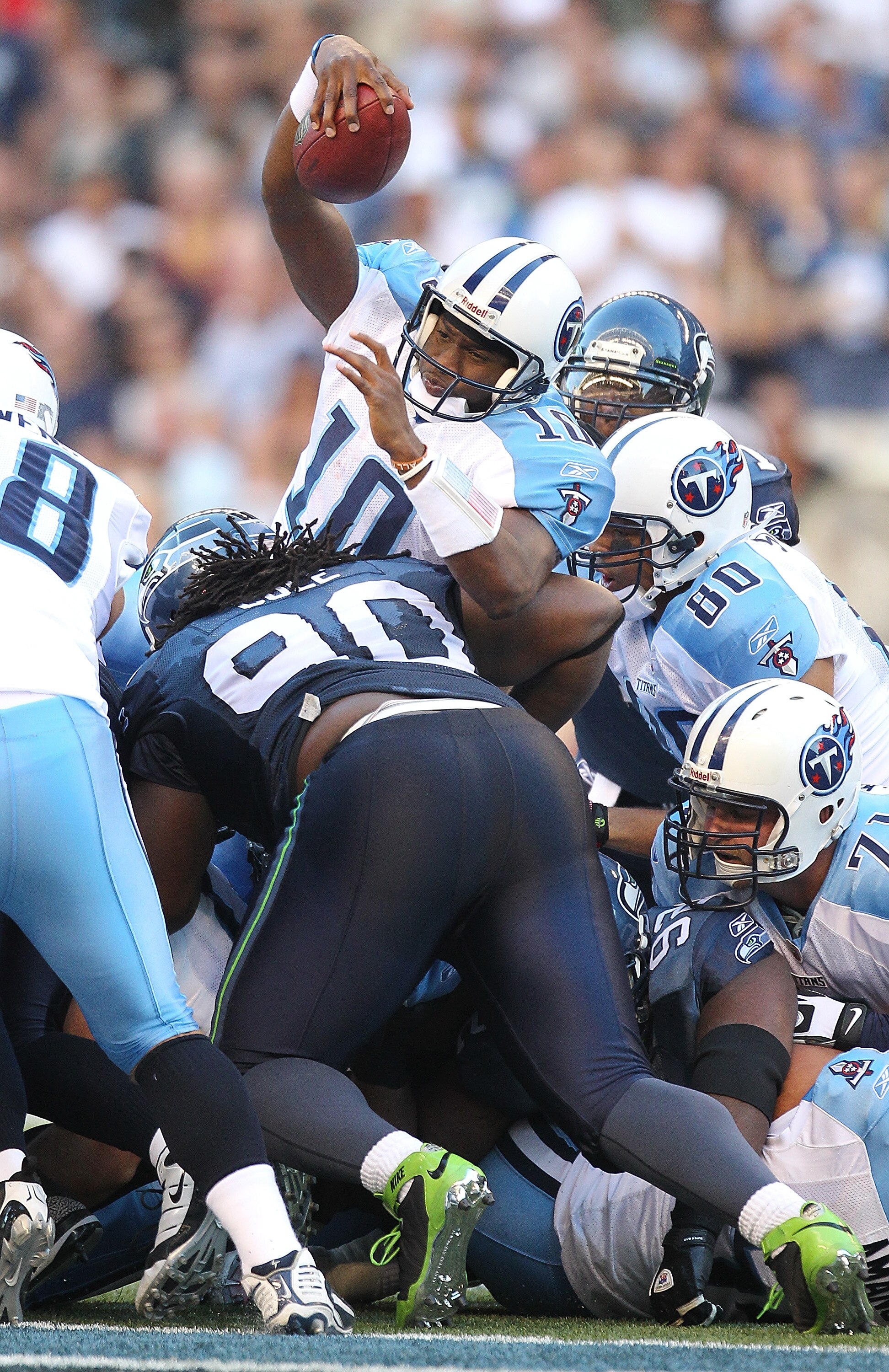 SEATTLE - AUGUST 14: Quarterback Vince Young #10 of the Tennessee Titans rushes on a quarterback sneak for a first down during the preseason game against the Seattle Seahawks at Qwest Field on August 14, 2010 in Seattle, Washington. (Photo by Otto Greule