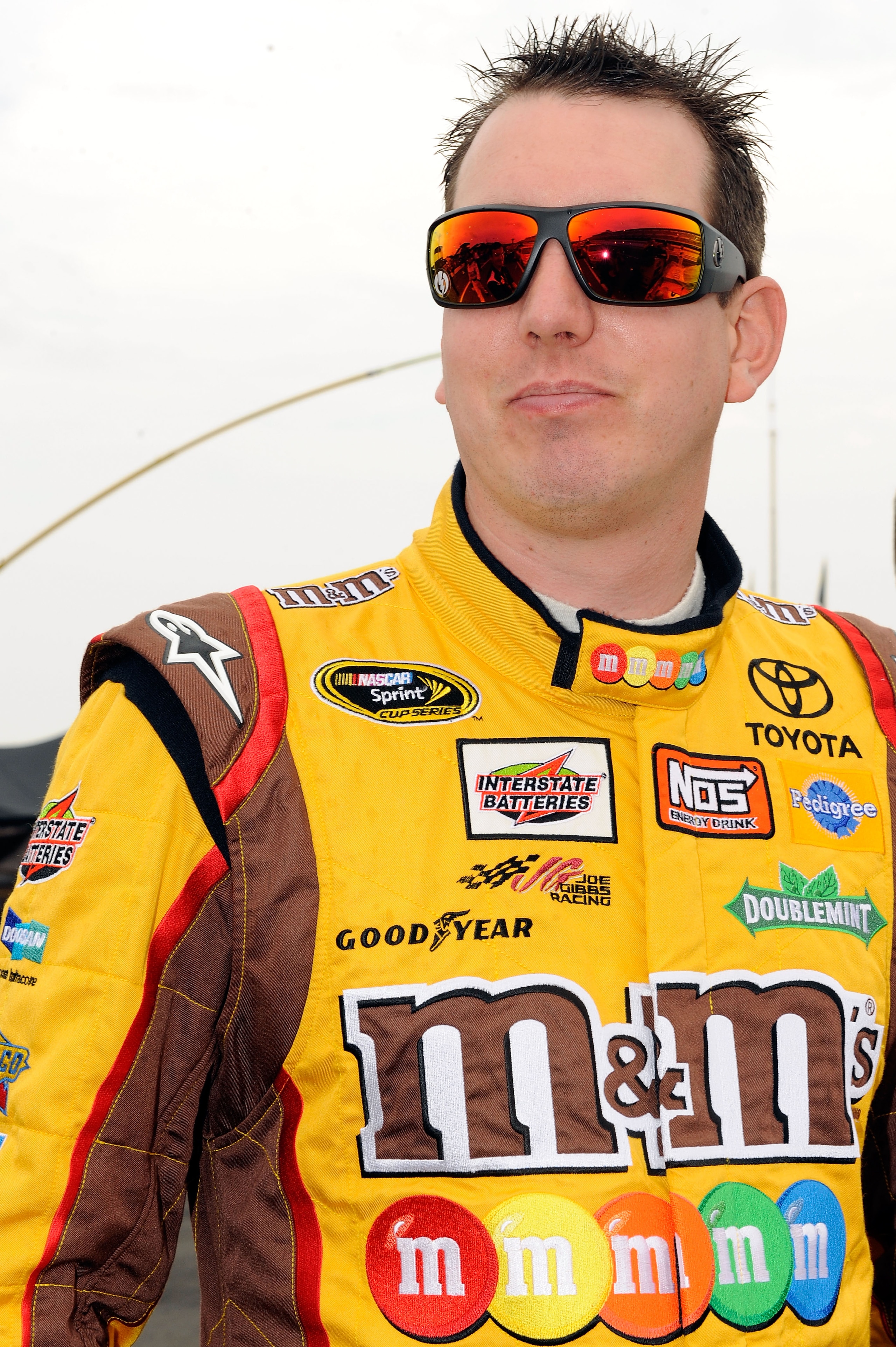 LONG POND, PA - AUGUST 01:  Kyle Busch, driver of the #18 M&M's Toyota, stands on the grid prior to the start of the NASCAR Sprint Cup Series Sunoco Red Cross Pennsylvania 500 at Pocono Raceway on August 1, 2010 in Long Pond, Pennsylvania.  (Photo by John