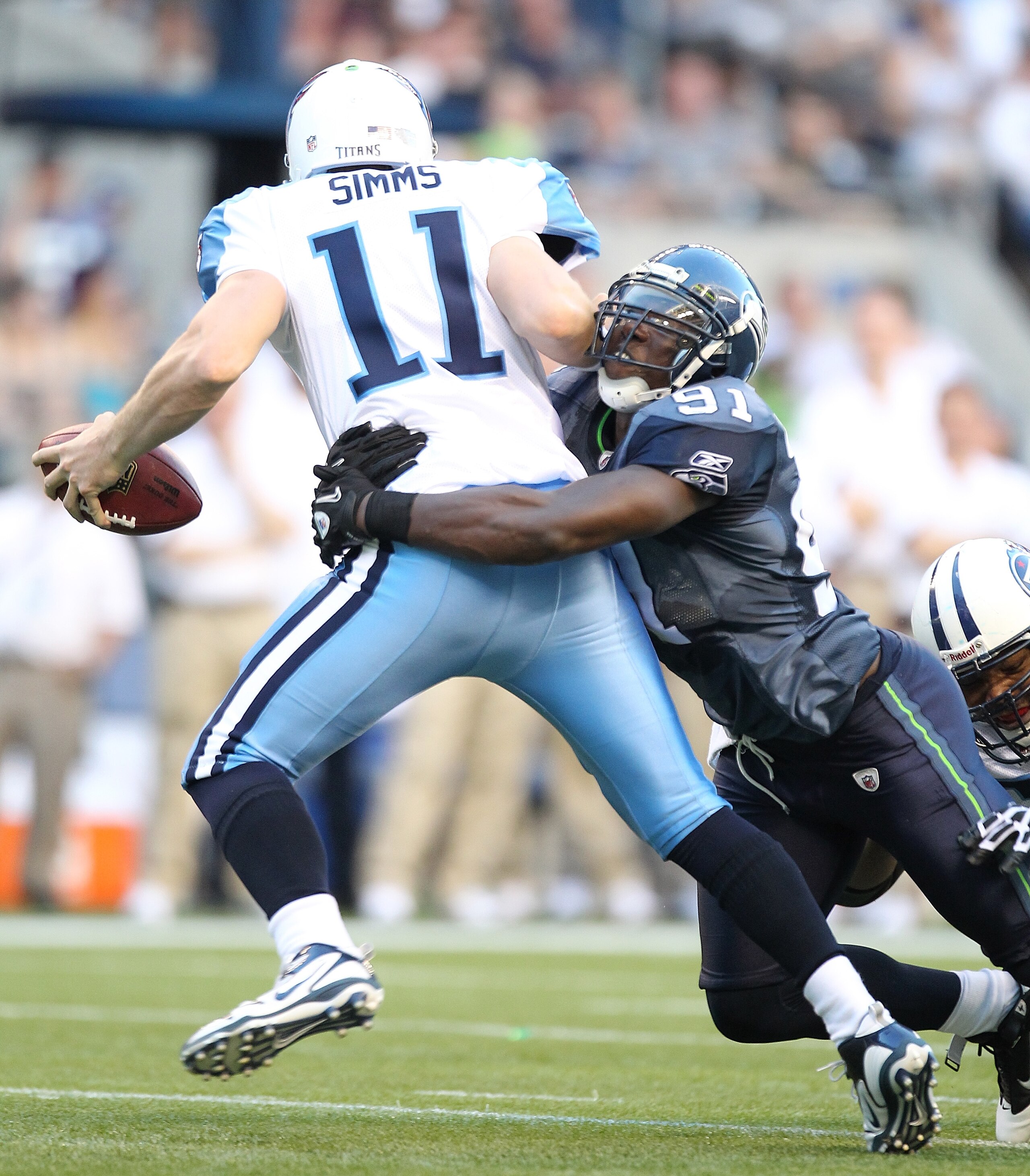 SEATTLE - AUGUST 14:  Chris Clemons #91 of the Seattle Seahawks sacks quarterback Chris Simms #11 during the preseason game against the Tennessee Titans at Qwest Field on August 14, 2010 in Seattle, Washington. (Photo by Otto Greule Jr/Getty Images)