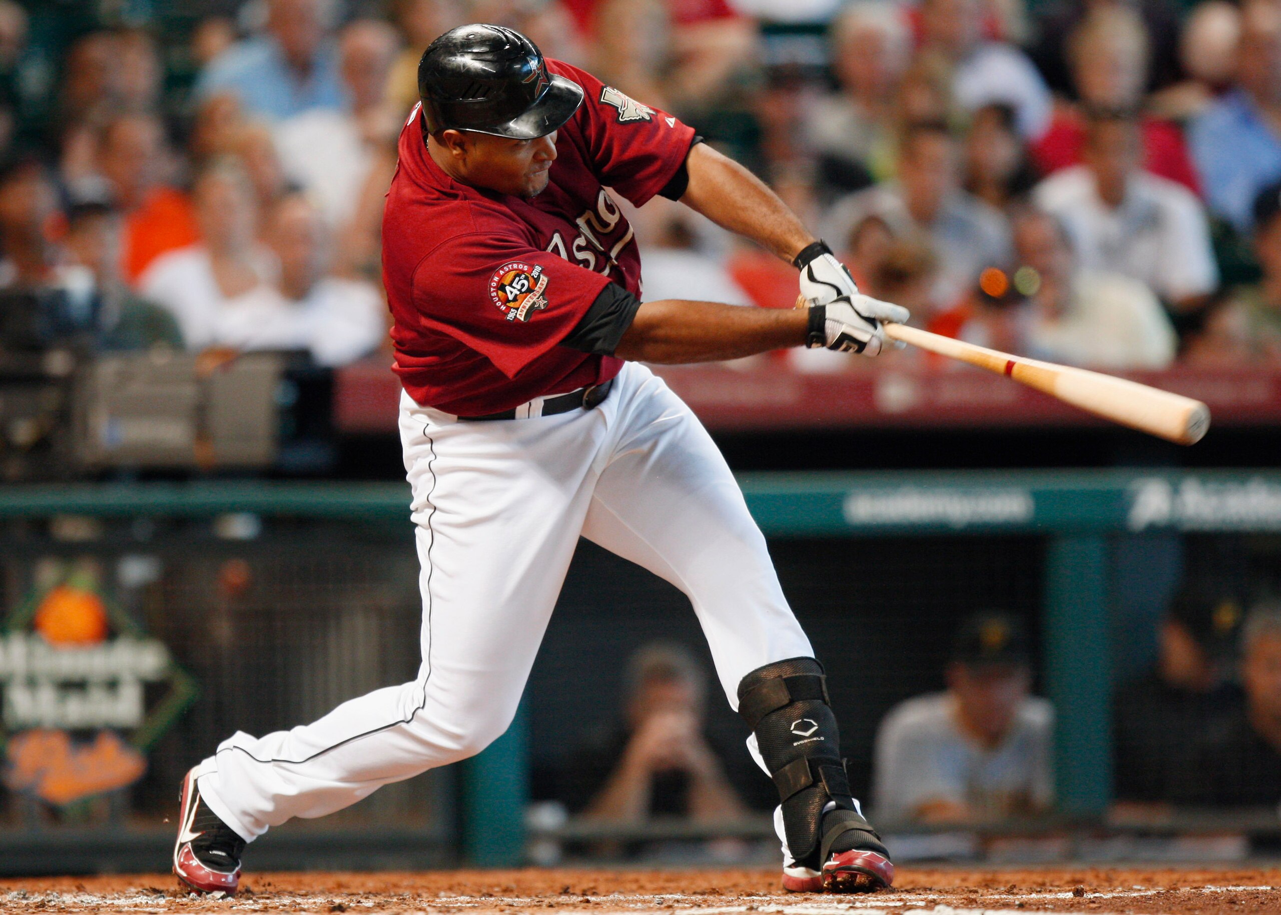 HOUSTON - AUGUST 15:  Carlos Lee #45 of the Houston Astros singles up the middle scoring Hunter Pence from second base during a baseball game against the Pittsburgh Pirates at Minute Maid Park on August 15, 2010 in Houston, Texas.  (Photo by Bob Levey/Get