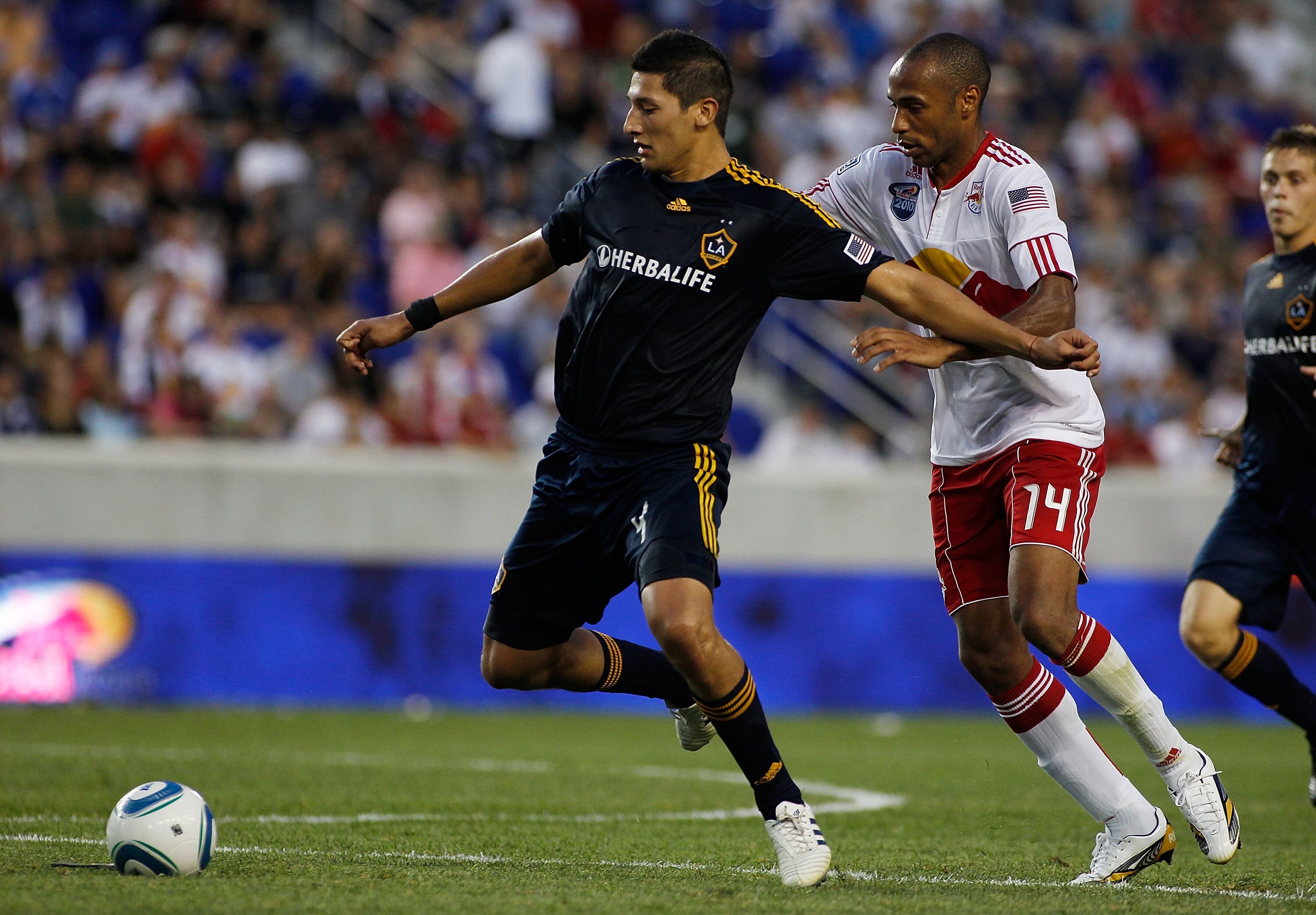 HARRISON, NJ - AUGUST 14:  Omar Gonzalez #4 of the Los Angeles Galaxy controls the ball in front of Thierry Henry #14 of the New York Red Bulls on August 14, 2010 at Red Bull Arena in Harrison, New Jersey. Galaxy defeat the Red Bulls 1-0. (Photo by Mike S