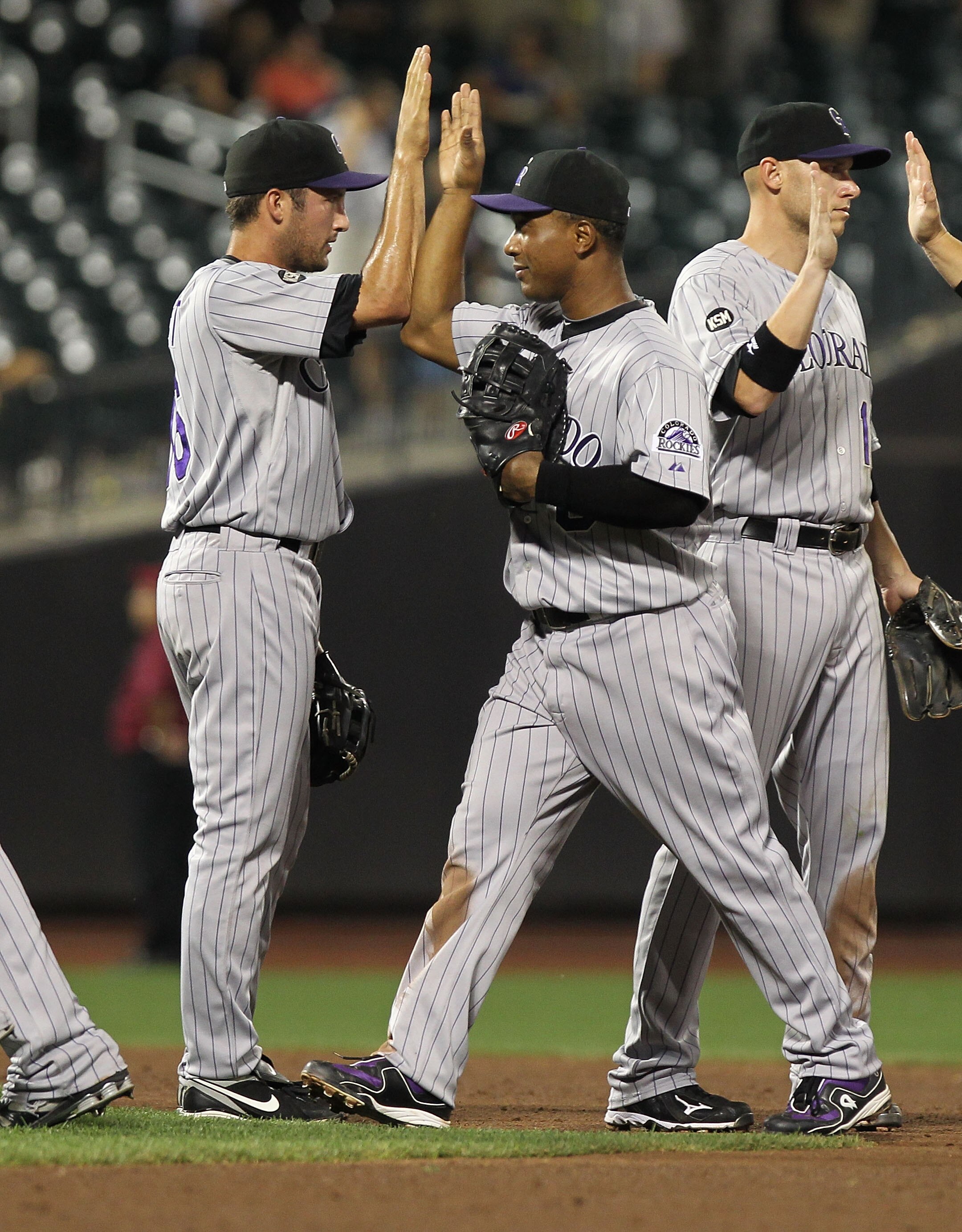 NEW YORK - AUGUST 11:  Melvin Mora #6 of the Colorado Rockies celebrates the win with teammate Huston Street #16 against the New York Mets at Citi Field on August 11, 2010 in the Flushing neighborhood of the Queens borough of New York City.  (Photo by Nic