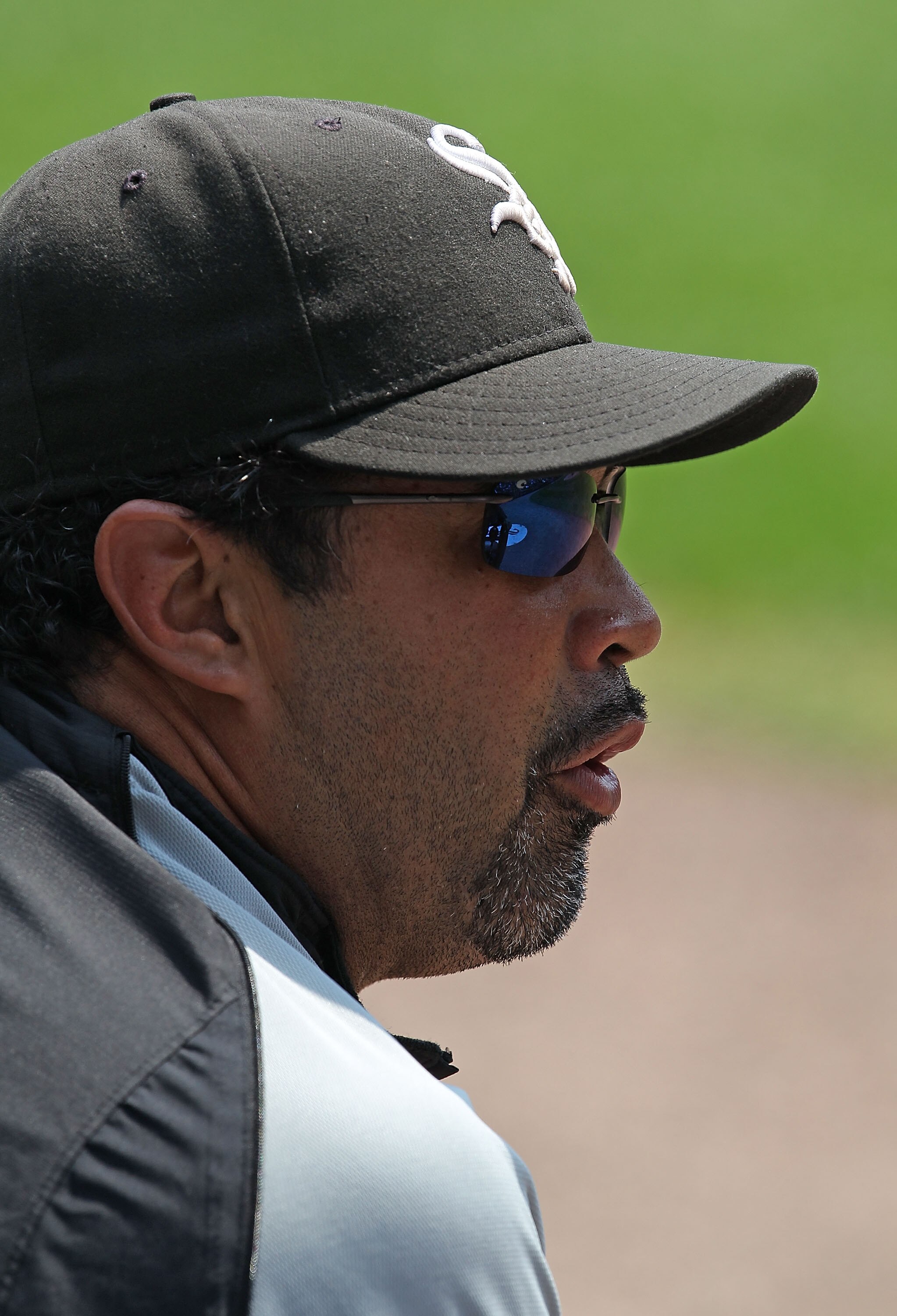 CHICAGO - AUGUST 01: Manager Ozzie Guillen #13 of the Chicago White Sox talks with his bench coach before a win over the Oakland Athletics at U.S. Cellular Field on August 1, 2010 in Chicago, Illinois. The White Sox defeated the Athletics 4-1. (Photo by J