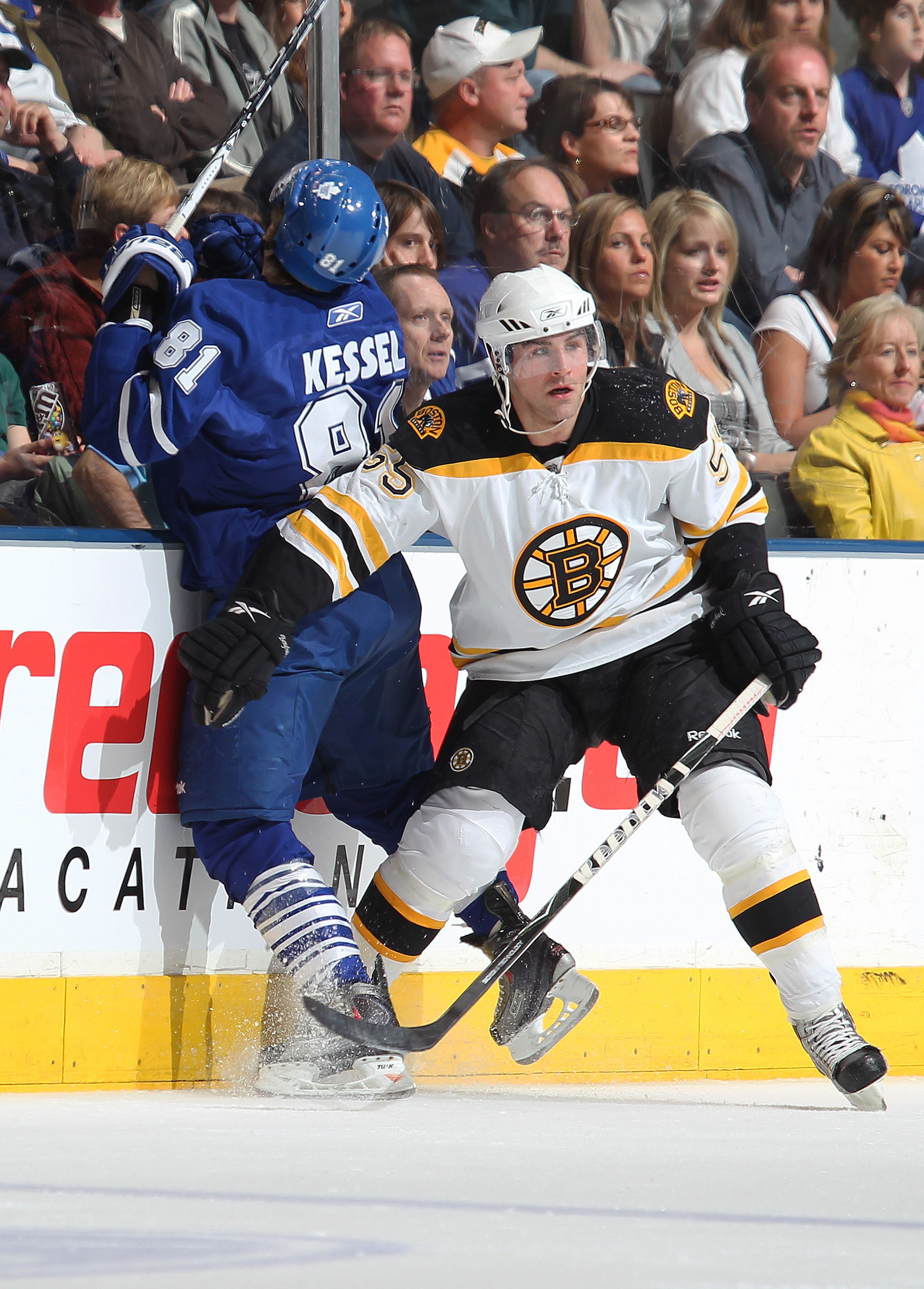 TORONTO,ON - APRIL 3:  Daniel Paille #20 of the Boston Bruins hammers Phil Kessel #81 of the Toronto Maple Leafs into the boards in a game on April 3, 2010 at the Air Canada Centre in Toronto, Ontario. (Photo by Claus Andersen/Getty Images)