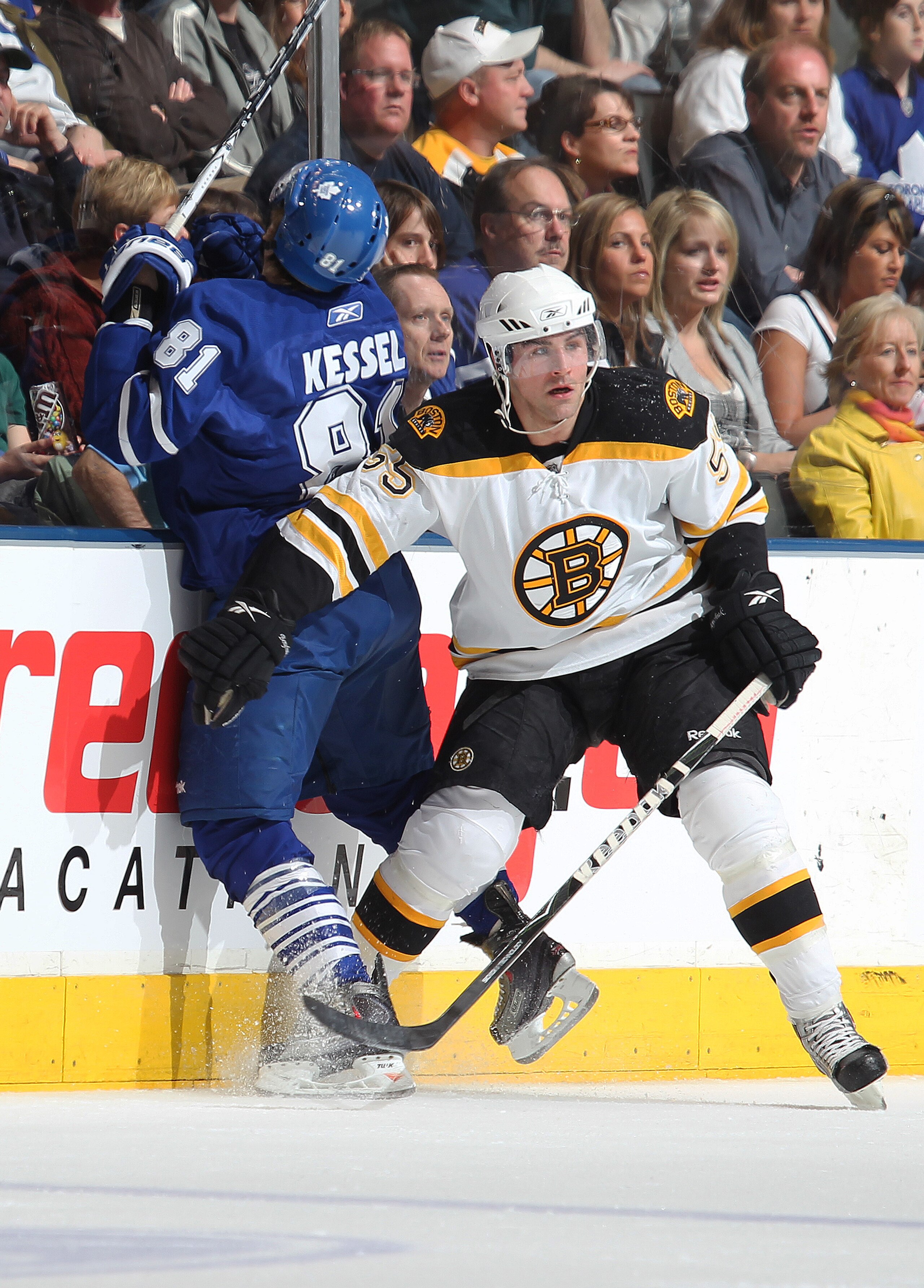 TORONTO,ON - APRIL 3:  Daniel Paille #20 of the Boston Bruins hammers Phil Kessel #81 of the Toronto Maple Leafs into the boards in a game on April 3, 2010 at the Air Canada Centre in Toronto, Ontario. (Photo by Claus Andersen/Getty Images)