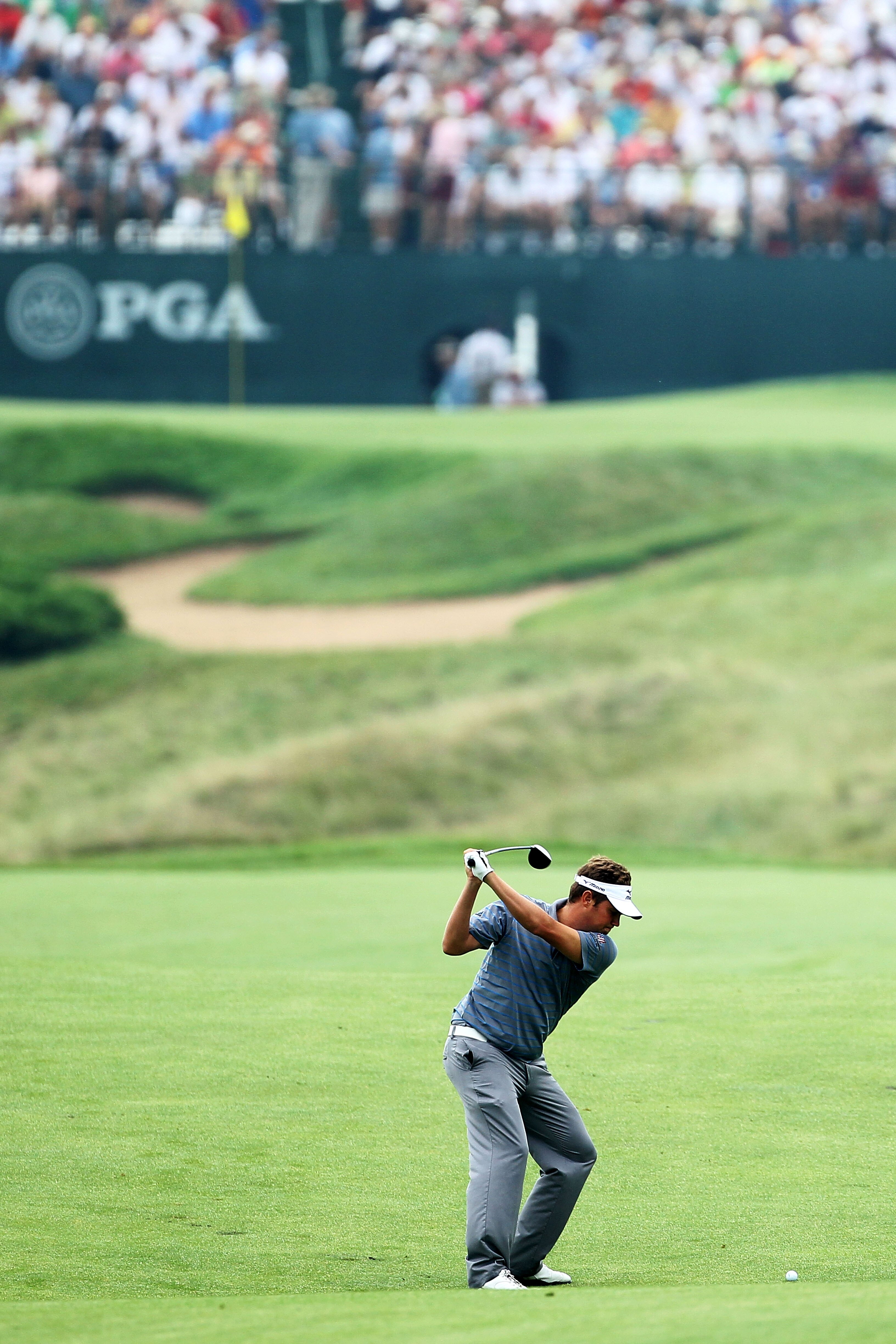 KOHLER, WI - AUGUST 13:  Jeff Overton hits his approach shot on the 16th hole during the continuation of the first round of the 92nd PGA Championship on the Straits Course at Whistling Straits on August 13, 2010 in Kohler, Wisconsin.  (Photo by Andy Lyons