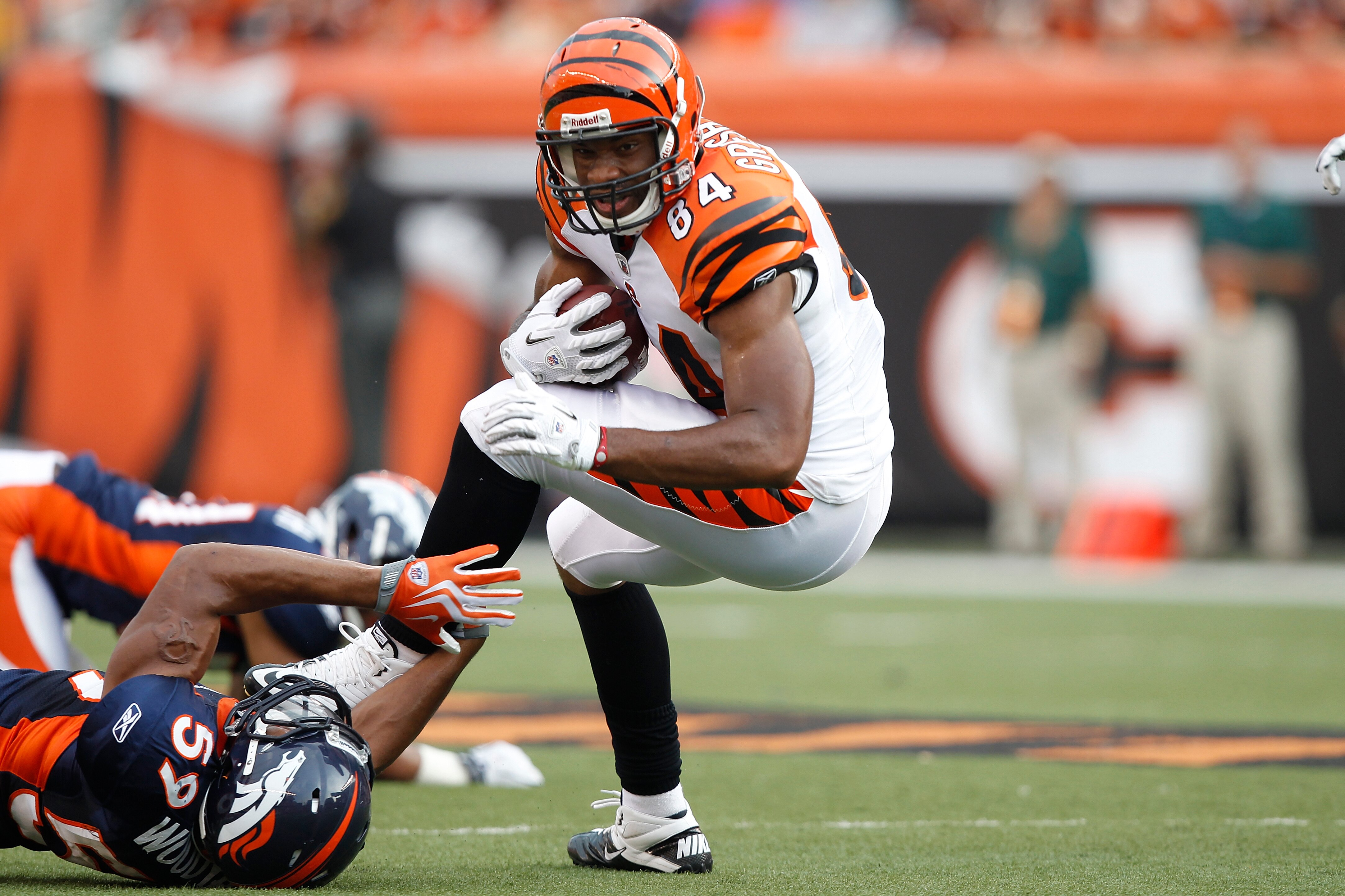 CINCINNATI, OH - AUGUST 15: Jermaine Gresham #84 of the Cincinnati Bengals gets tackled after catching a pass by Wesley Woodyard #59 of the Denver Broncos during a preseason game at Paul Brown Stadium on August 15, 2010 in Cincinnati, Ohio. The Bengals wo