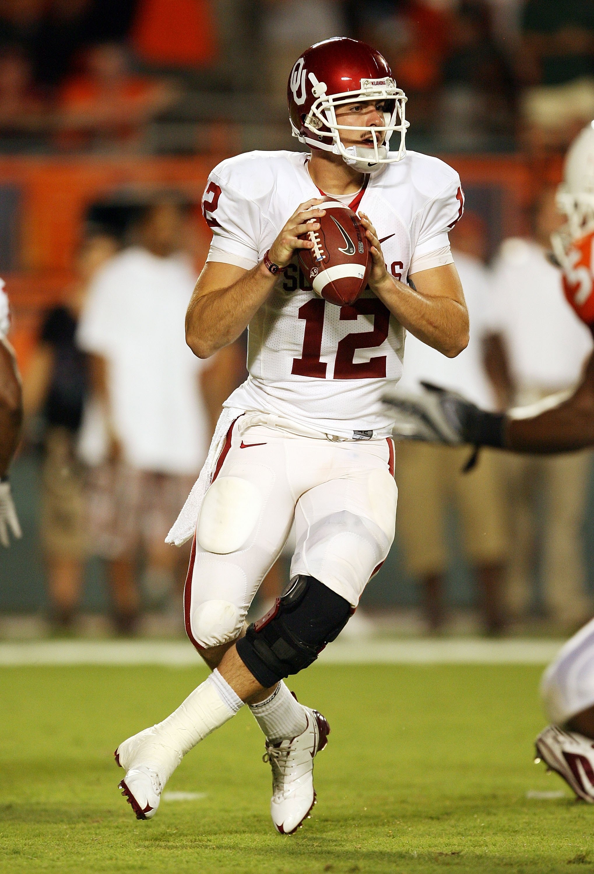 MIAMI GARDENS, FL - OCTOBER 03:  Quarterback Landry Jones #12 of the Oklahoma Sooners drops back to pass against the Miami Hurricanes at Land Shark Stadium on October 3, 2009 in Miami Gardens, Florida. Miami defeated Oklahoma 21-20.  (Photo by Doug Benc/G