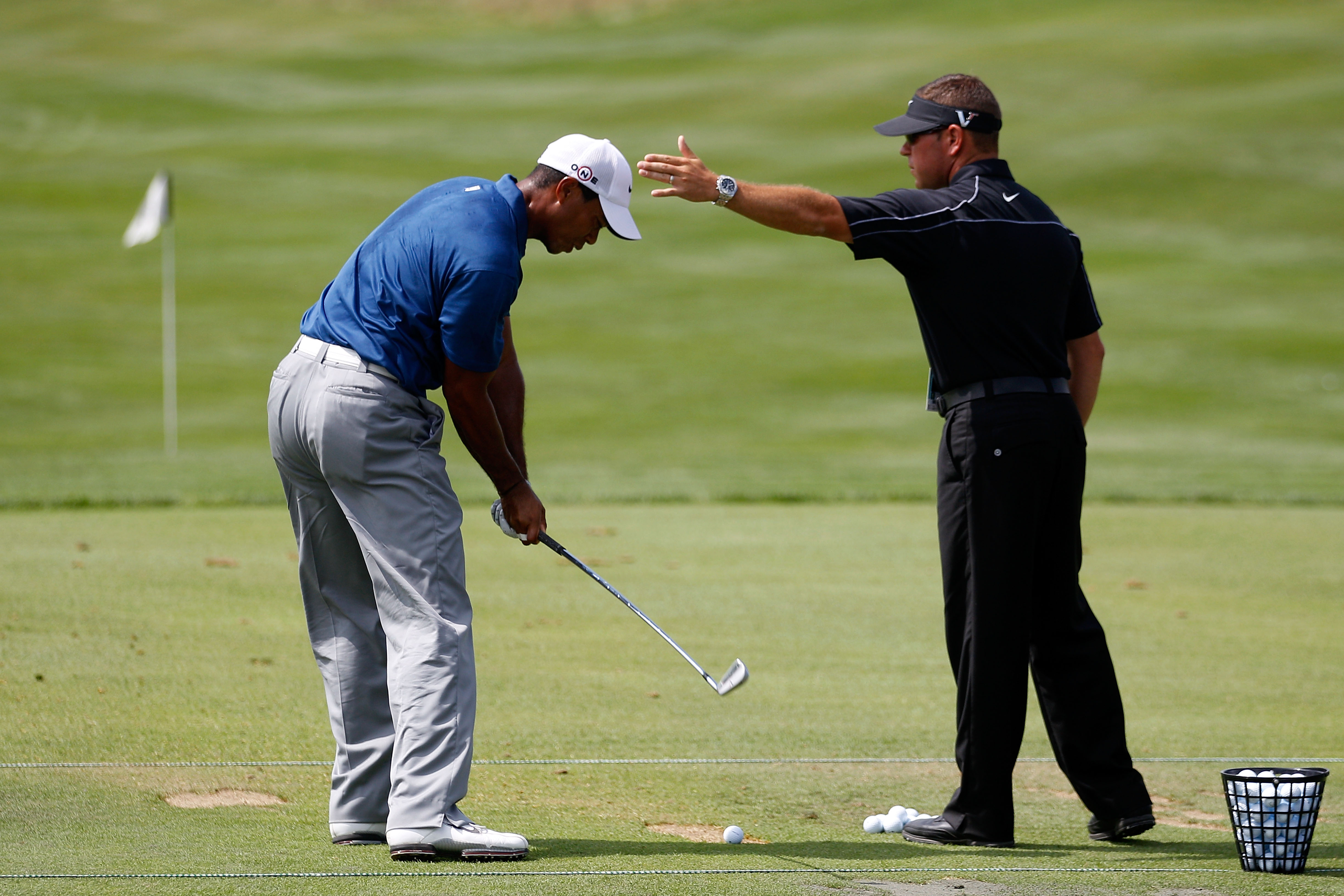 KOHLER, WI - AUGUST 14:  Tiger Woods works with golf instructor Sean Foley on the practice ground prior to the start of the third round of the 92nd PGA Championship on the Straits Course at Whistling Straits on August 14, 2010 in Kohler, Wisconsin.  (Phot