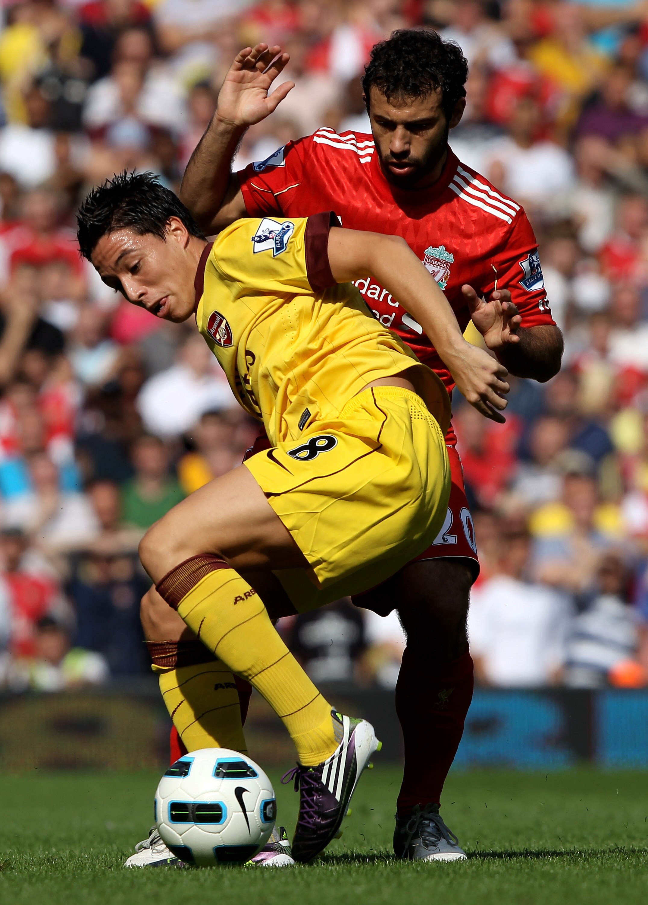 LIVERPOOL, ENGLAND - AUGUST 15:  Samir Nasri of Arsenal is challenged by Javier Mascherano of Liverpool during the Barclays Premier League match between Liverpool and Arsenal at Anfield on August 15, 2010 in Liverpool, England.  (Photo by Clive Brunskill/