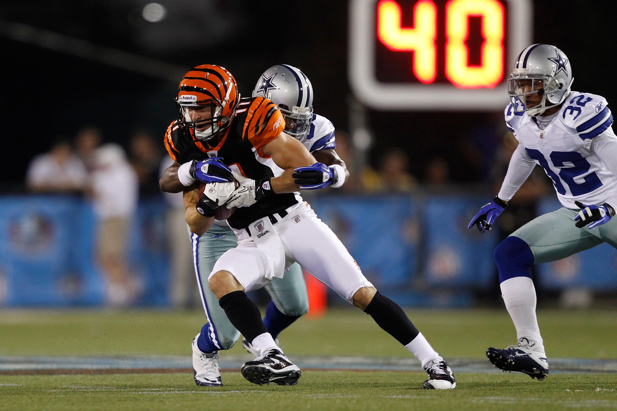 CANTON, OH - AUGUST 8: Jordan Shipley #11 of the Cincinnati Bengals tries to break a tackle after catching a pass against the Dallas Cowboys during the 2010 Pro Football Hall of Fame Game at the Pro Football Hall of Fame Field at Fawcett Stadium on August