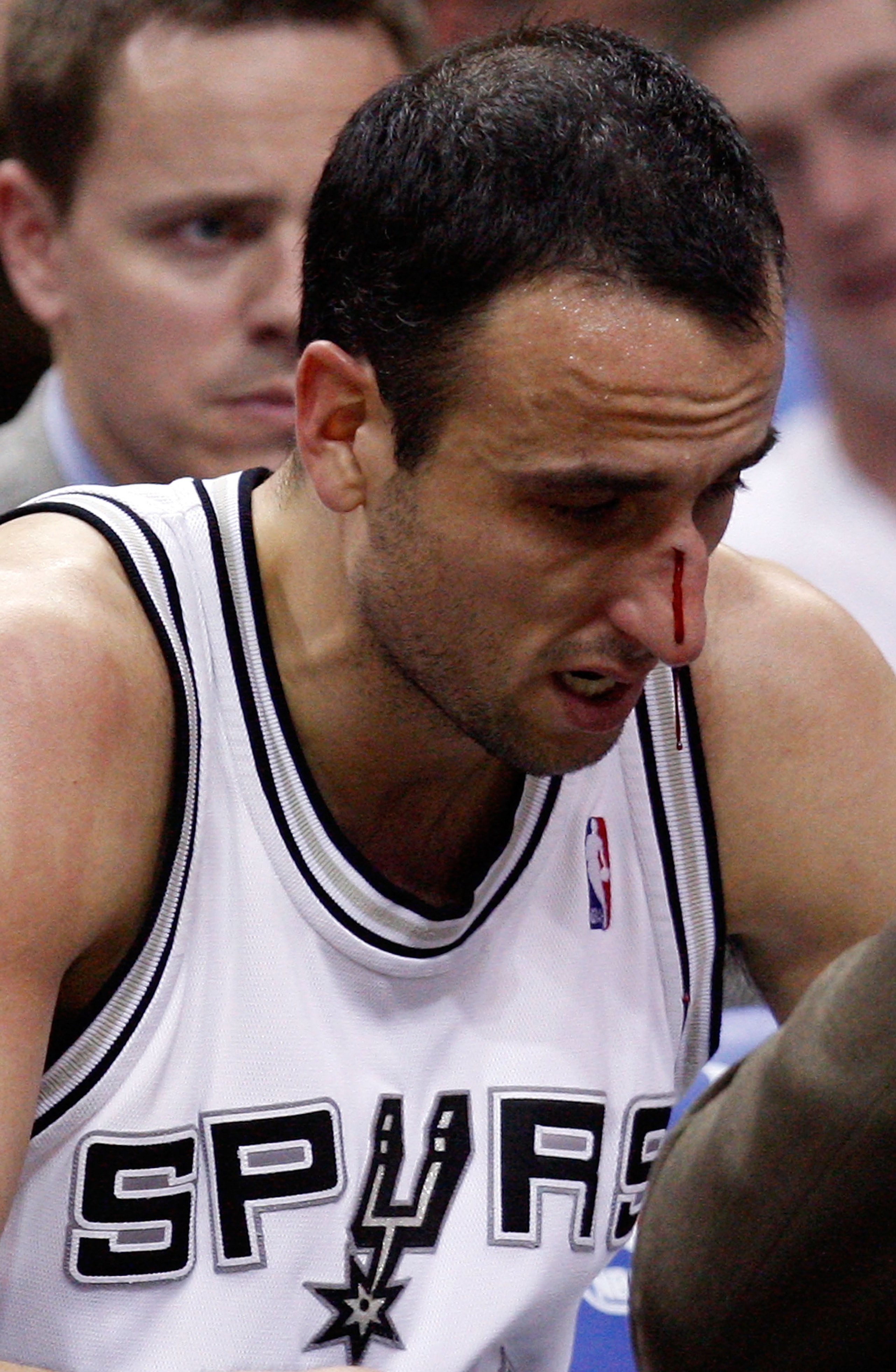 SAN ANTONIO - APRIL 23:  Guard Manu Ginobili #20 of the San Antonio Spurs is attended to after being hit in the nose against the Dallas Mavericks in Game Three of the Western Conference Quarterfinals during the 2010 NBA Playoffs at AT&T Center on April 23
