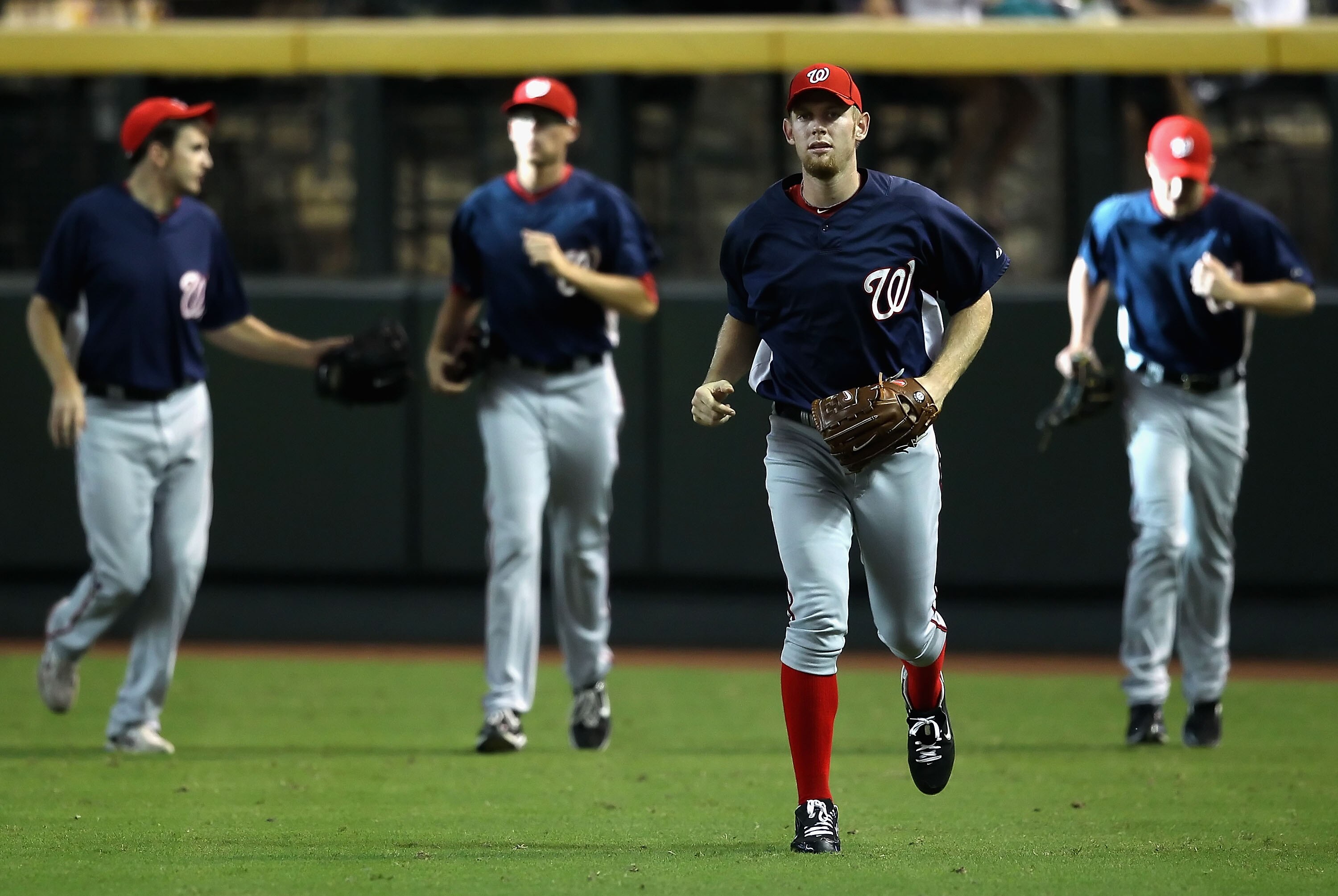 PHOENIX - AUGUST 04:  Pitcher Stephen Strasburg #37 (2nd from right) of the Washington Nationals warms up in the outfield before the Major League Baseball game against the Arizona Diamondbacks at Chase Field on August 4, 2010 in Phoenix, Arizona.  (Photo 