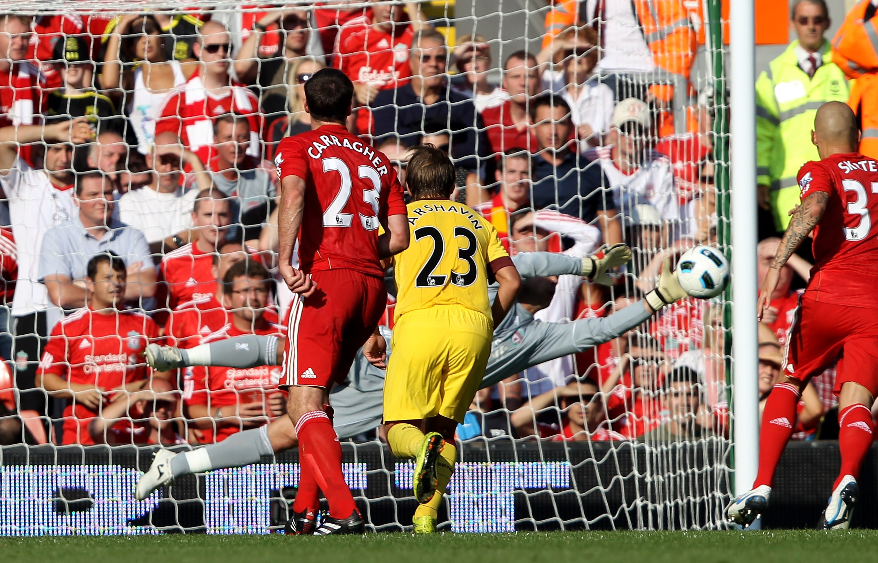 LIVERPOOL, ENGLAND - AUGUST 15:  Pepe Reina of Liverpool saves the attempt on goal of Andrey Arshavin of Arsenal during the Barclays Premier League match between Liverpool and Arsenal at Anfield on August 15, 2010 in Liverpool, England.  (Photo by Clive B