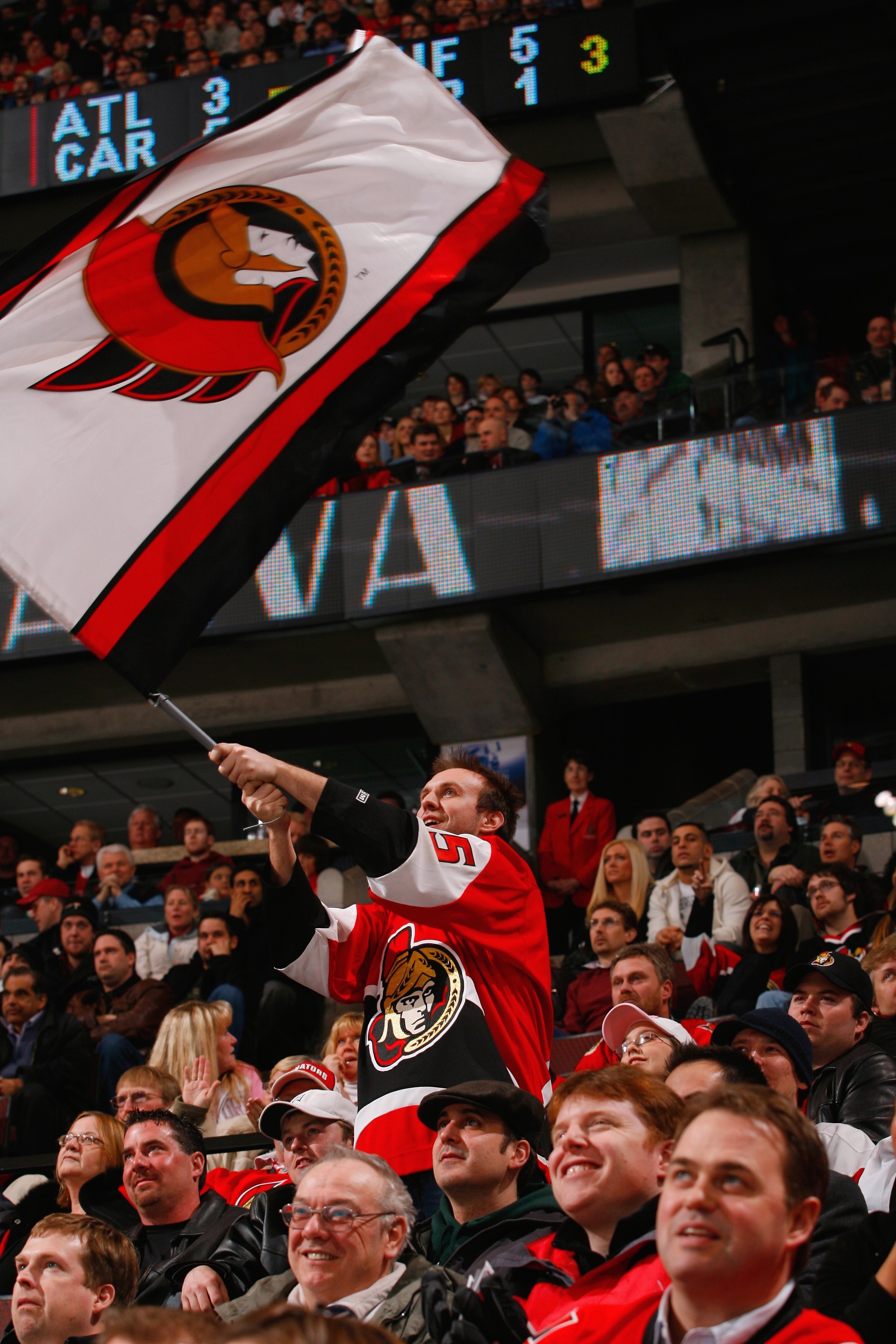 OTTAWA, CANADA- FEBRUARY 21:  An Ottawa Senators fan waves a flag as he shows his support during the Senators' NHL game against the Columbus Blue Jackets on February 21, 2008 at the Scotiabank Place in Ottawa, Canada.  The Columbus Blue Jackets defeated t