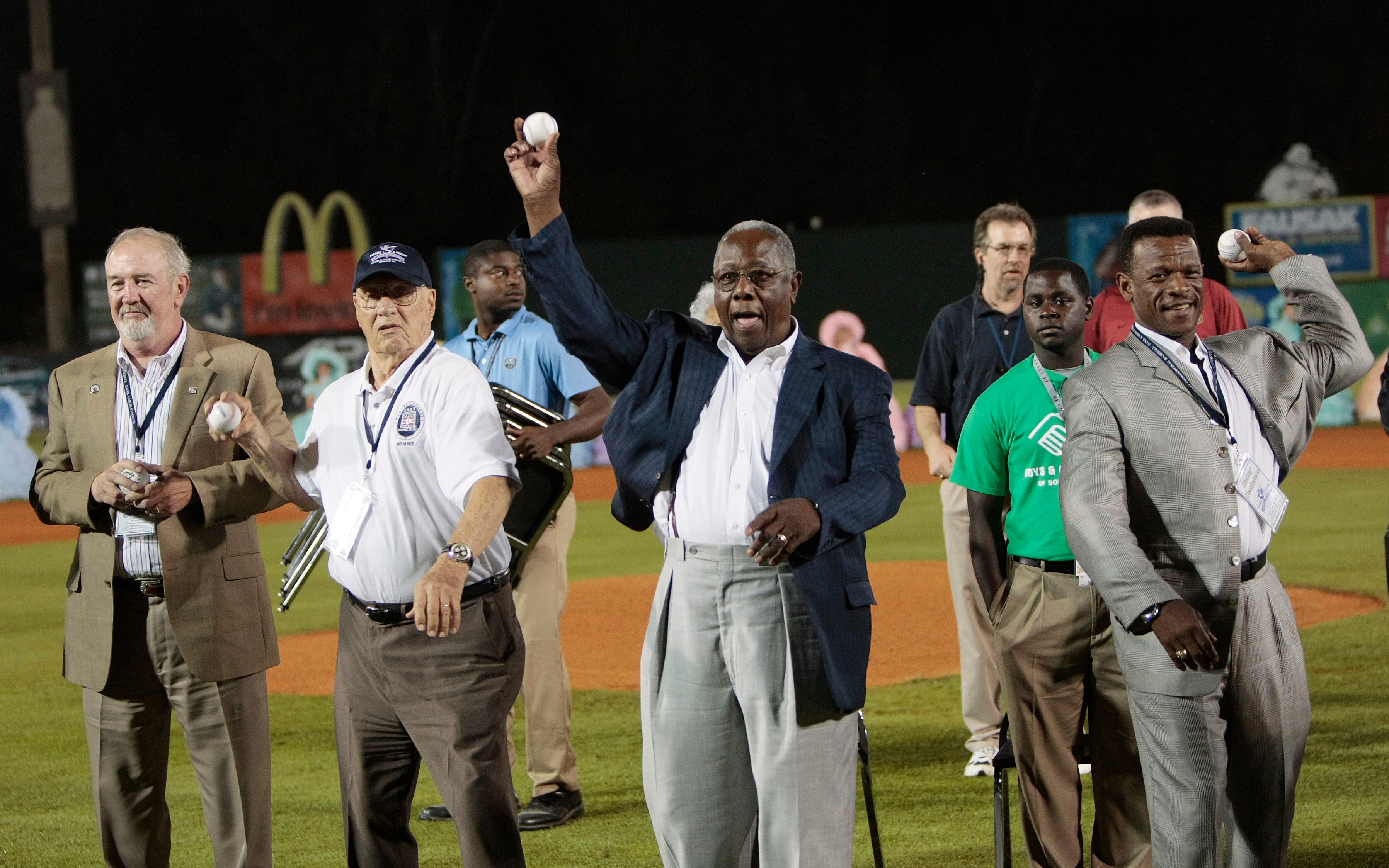 MOBILE, AL - APRIL 14: Baseball Hall of Famers (L-R) Bruce Sutter, Bob Feller, Hank Aaron and Rickey Henderson throw out the first pitch during pre-game ceremonies following the opening the Hank Aaron Museum at the Hank Aaron Stadium on April 14, 2010 in