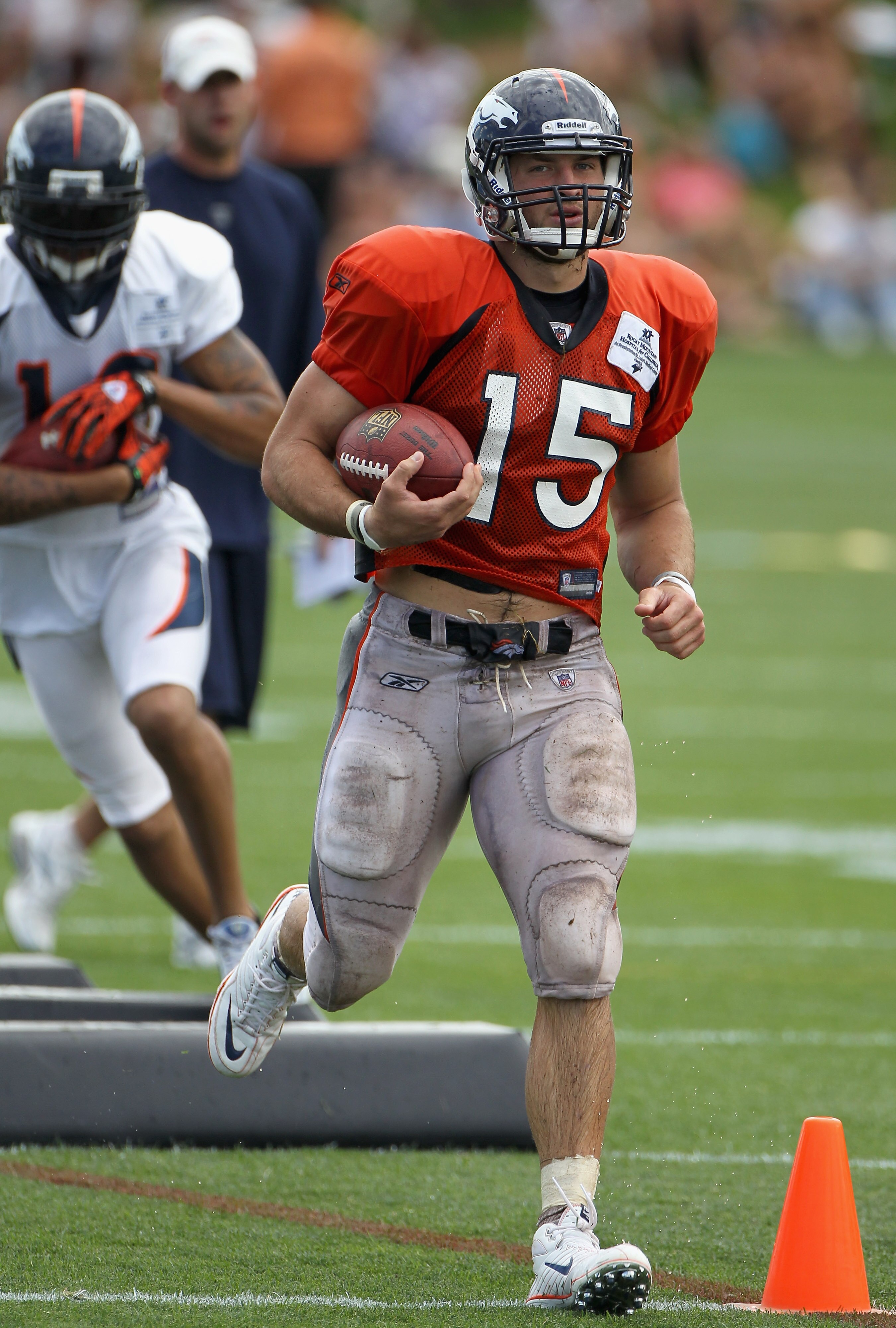 ENGLEWOOD, CO - AUGUST 05:  Quarterback Tim Tebow #15 of the Denver Bronocs takes part in practice during training camp at Dove Valley on August 5, 2010 in Englewood, Colorado.  (Photo by Doug Pensinger/Getty Images)
