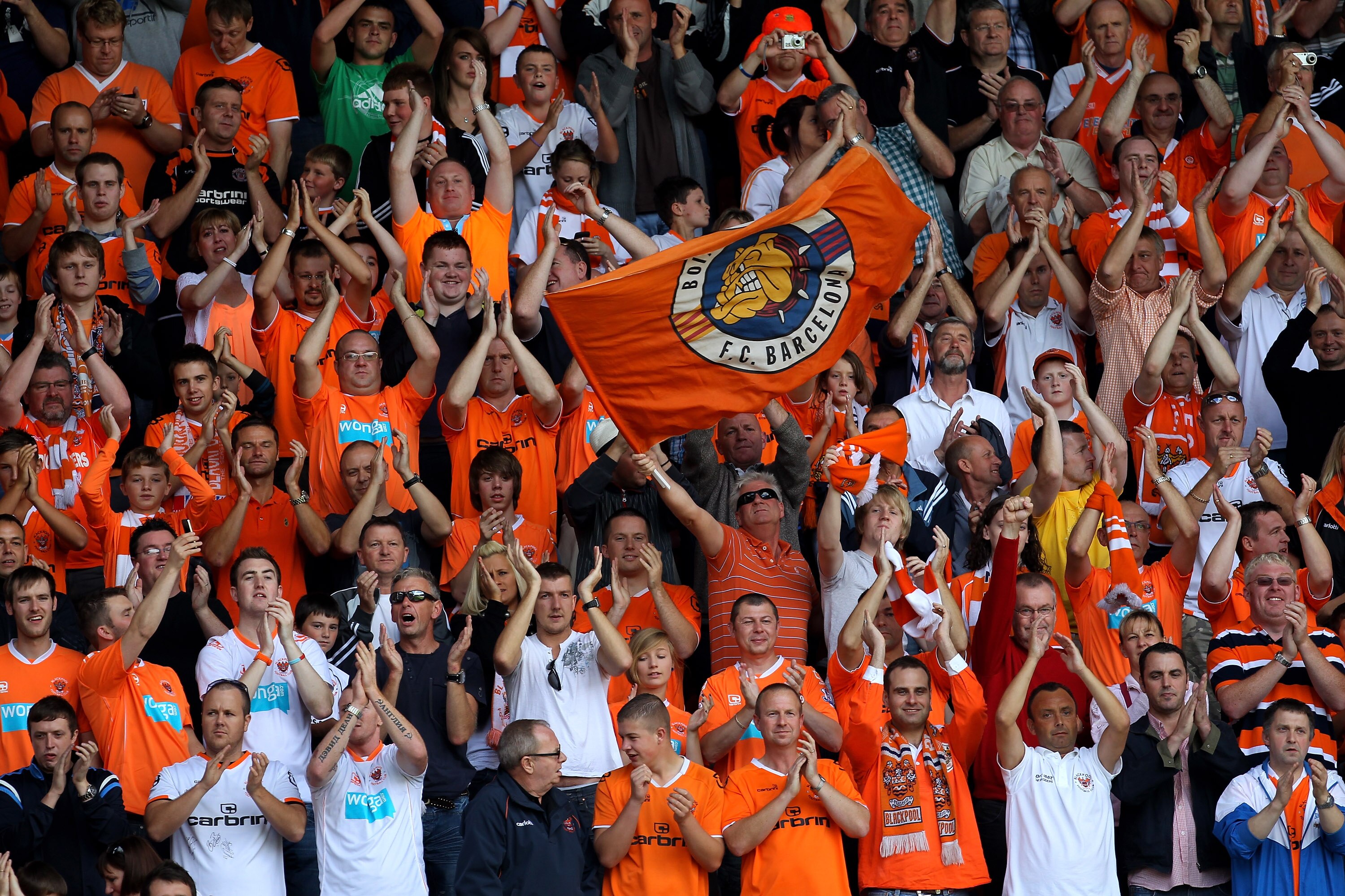 WIGAN, ENGLAND - AUGUST 14:  Blackpool fans show their support during the Barclays Premier League match between Wigan Athletic and Blackpool at the DW Stadium on August 14, 2010 in Wigan, England.  (Photo by Alex Livesey/Getty Images)