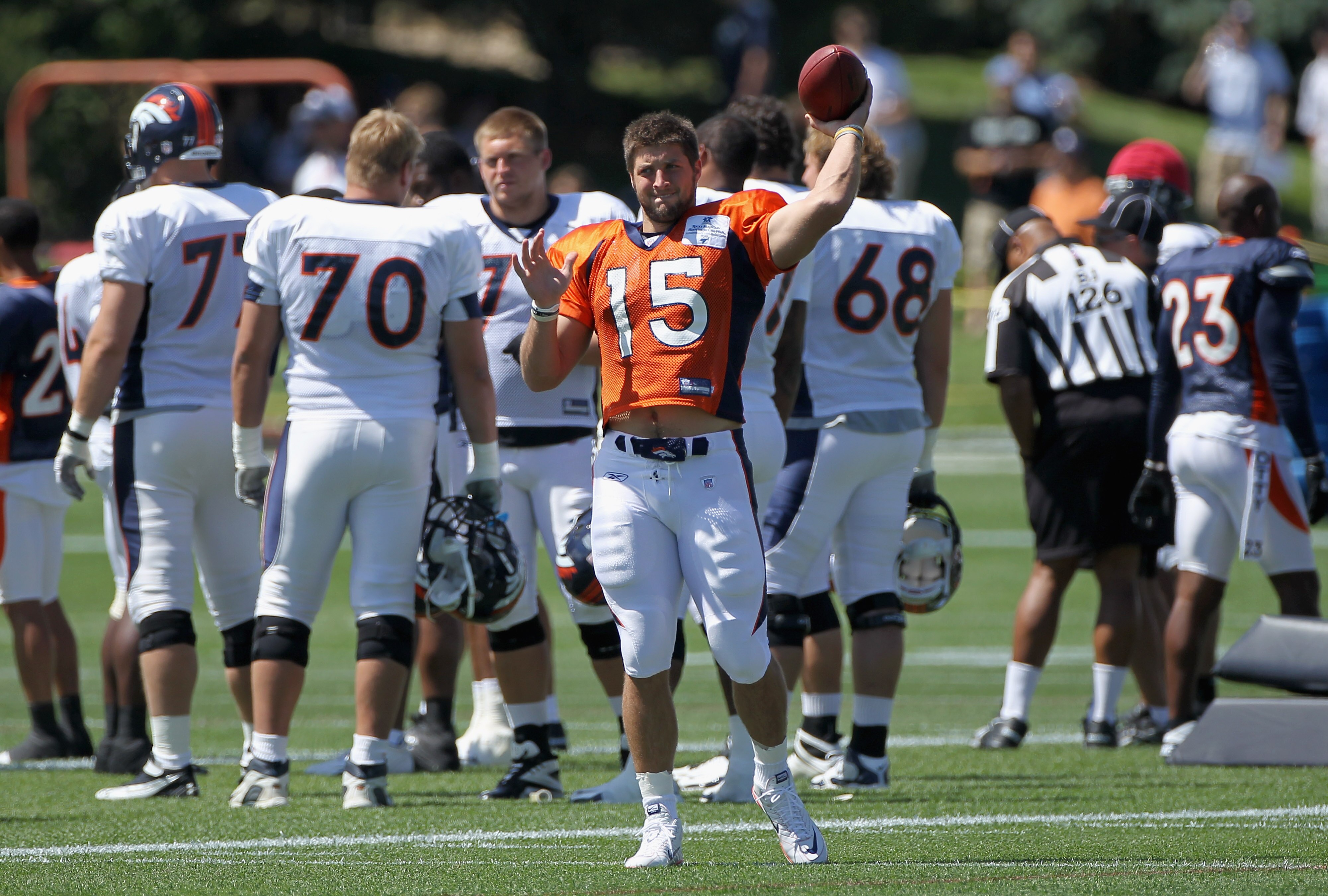 ENGLEWOOD, CO - AUGUST 05:  Rookie quarterback Tim Tebow #15 of the Denver Bronocs tosses the ball as he takes part in practice during training camp at Dove Valley on August 5, 2010 in Englewood, Colorado.  (Photo by Doug Pensinger/Getty Images)