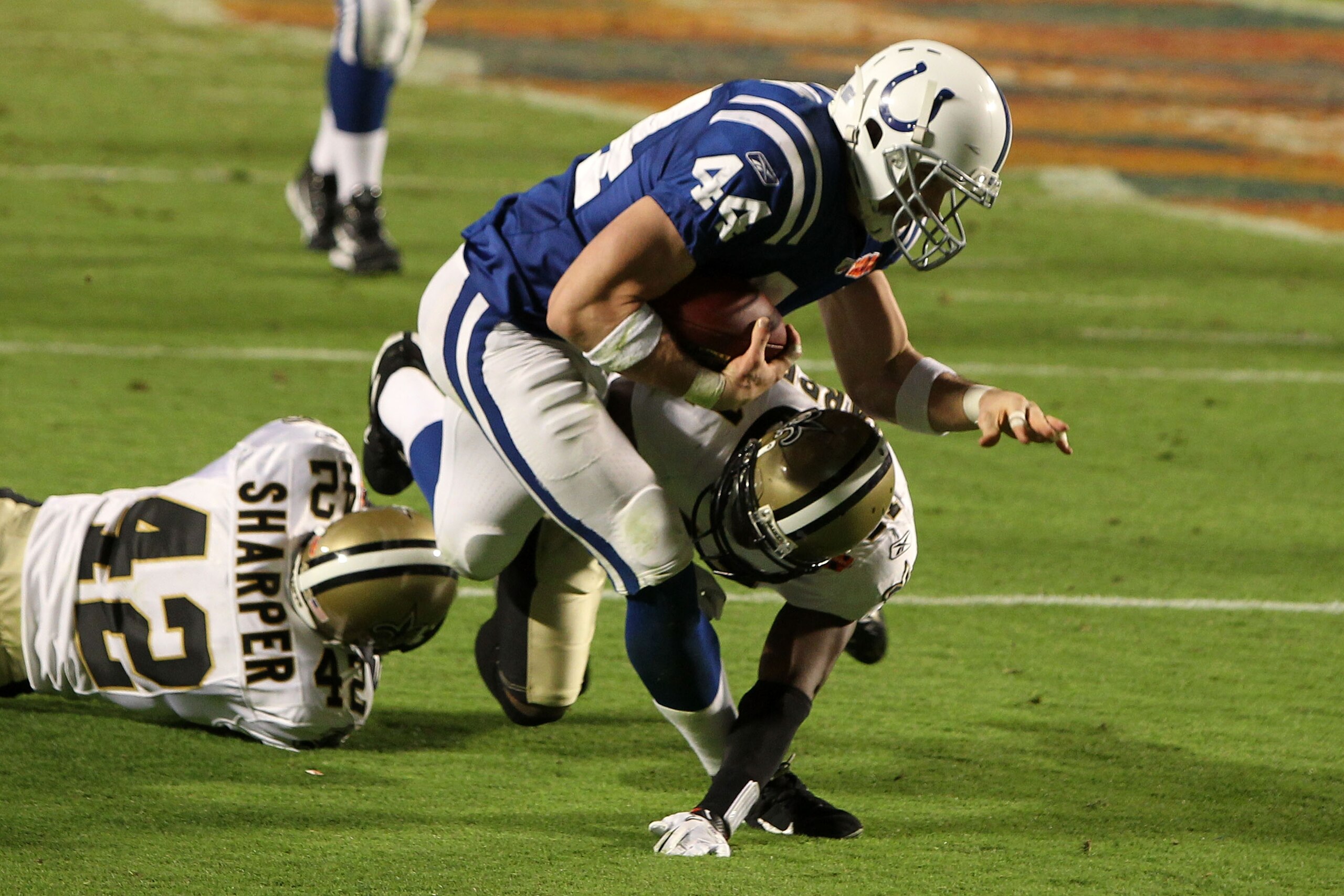 MIAMI GARDENS, FL - FEBRUARY 07:  Dallas Clark #44 of the Indianapolis Colts runs with the ball against Roman Harper #41 and Scott Shanle #58 of the New Orleans Saints during Super Bowl XLIV on February 7, 2010 at Sun Life Stadium in Miami Gardens, Florid