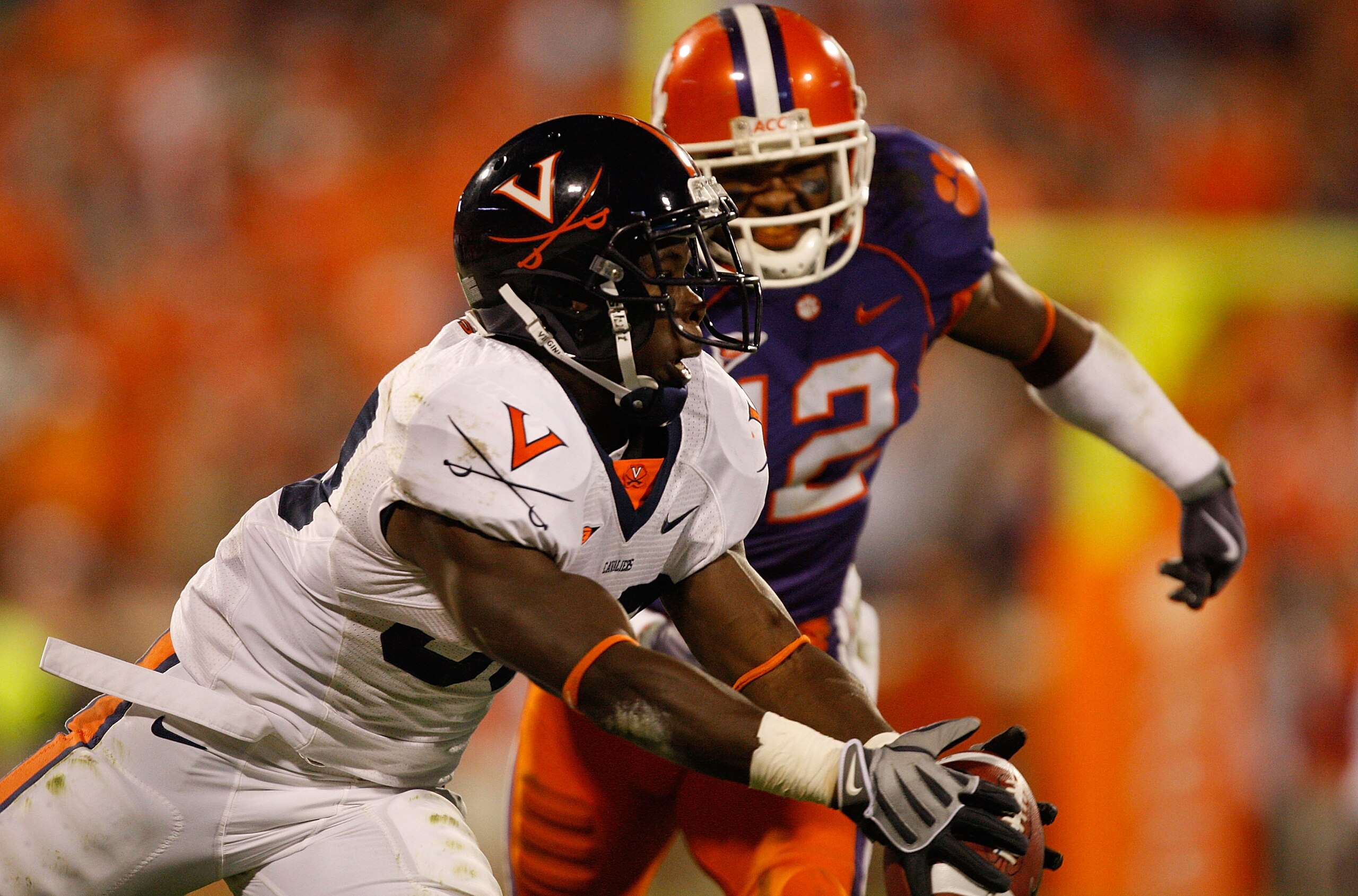 CLEMSON, SC - NOVEMBER 21:  Perry Jones #33 of the Virginia Cavaliers catches a ball as Marcus Gilchrist #12 of the Clemson Tigers tries to catch him during their game at Memorial Stadium on November 21, 2009 in Clemson, South Carolina.  (Photo by Streete