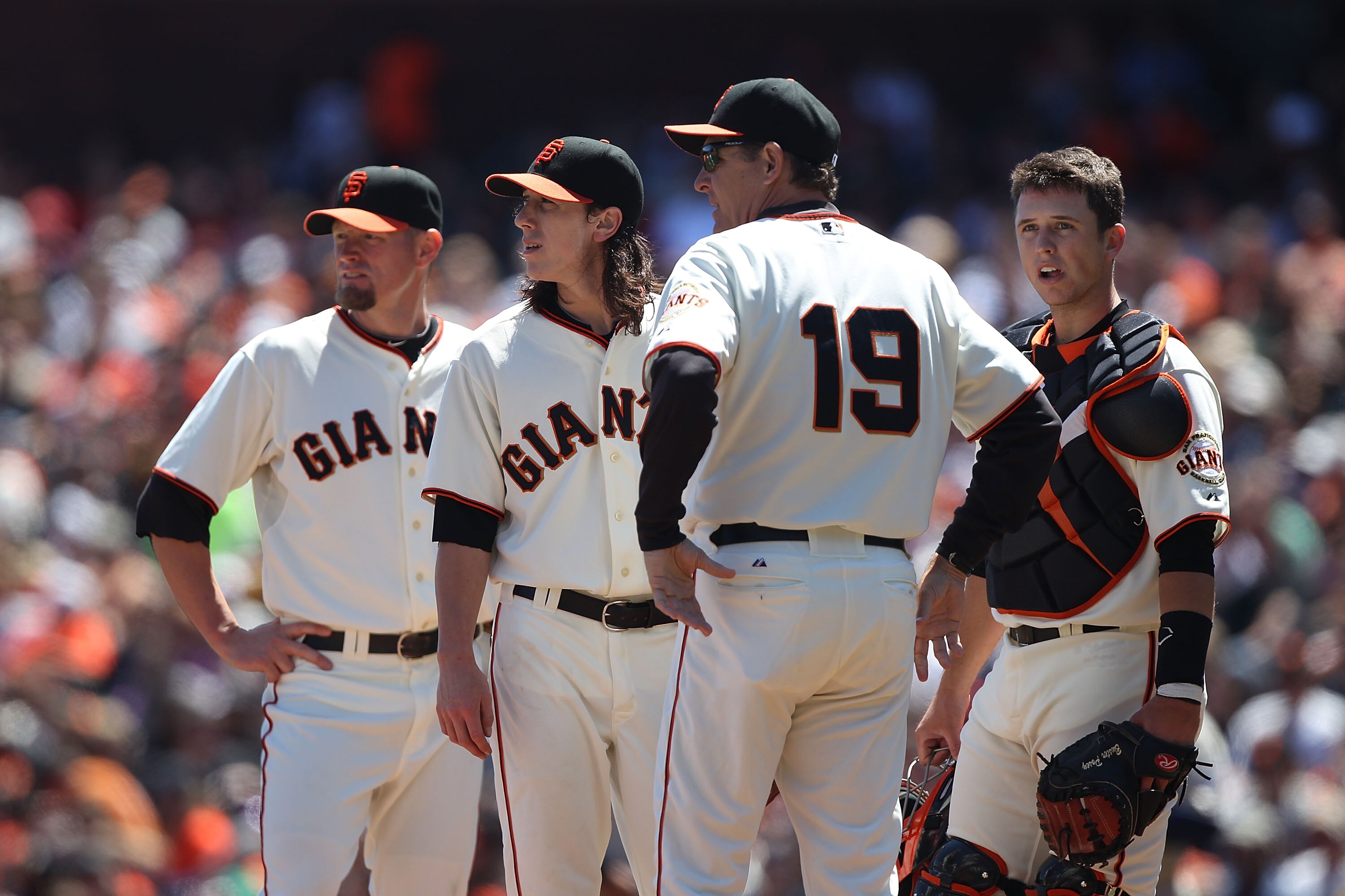 SAN FRANCISCO - AUGUST 15:  Pitcher Tim Lincecum #55 of the San Francisco Giants looks on with Aubey Huff #17, Dave Righetti #19 and catcher Buster Posey #28 against the San Diego Padres in the second innning during an MLB game at AT&T Park on August 15,