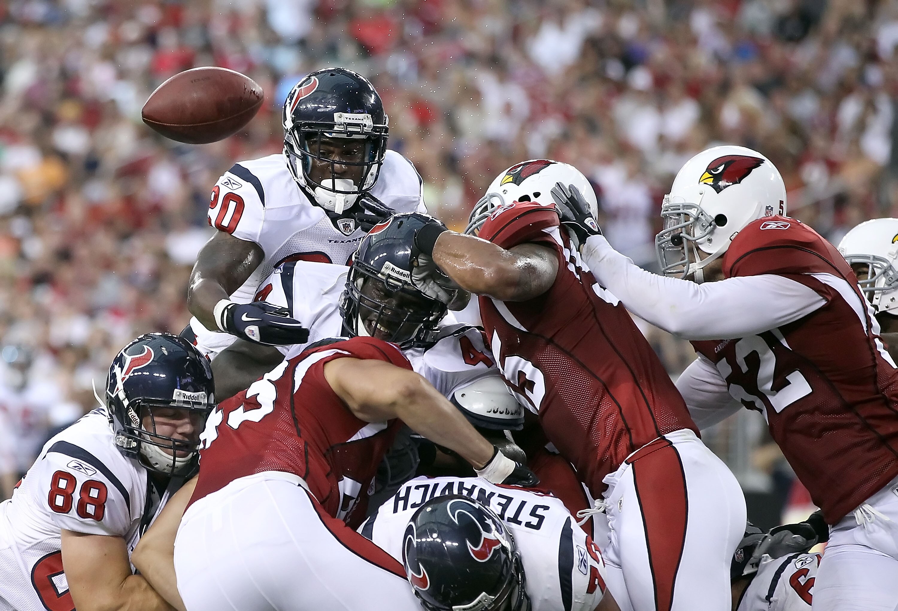 GLENDALE, AZ - AUGUST 14:  Runningback Steve Slaton #20 of the Houston Texans fumbles the ball as he attempts to score against the Arizona Cardinals during preseason NFL game at the University of Phoenix Stadium on August 14, 2010 in Glendale, Arizona. Th