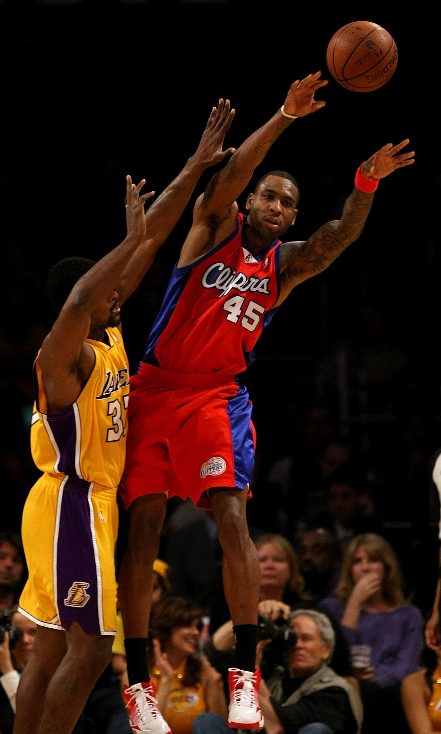 LOS ANGELES, CA - JANUARY 15:  Rasual Butler #45 of the Los Angeles Clippers passes the ball against Ron Artest #37 of the Los Angeles Lakers during the game on January 15, 2010 at Staples Center in Los Angeles, California. The Lakers won 126-86. NOTE TO